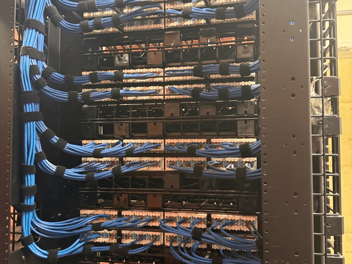 Server rack filled with network switches and blue ethernet cables in a data center