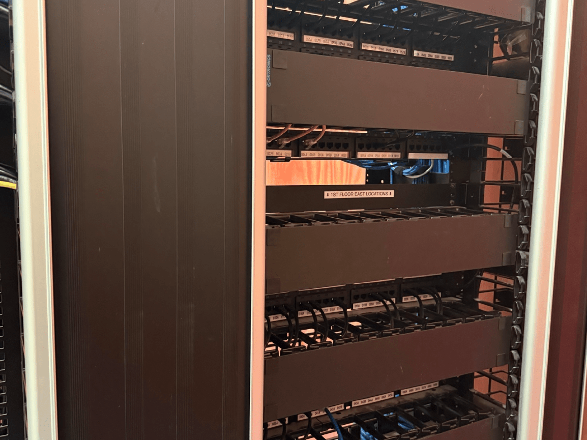 Server racks in a data center, with cables and equipment inside a cabinet