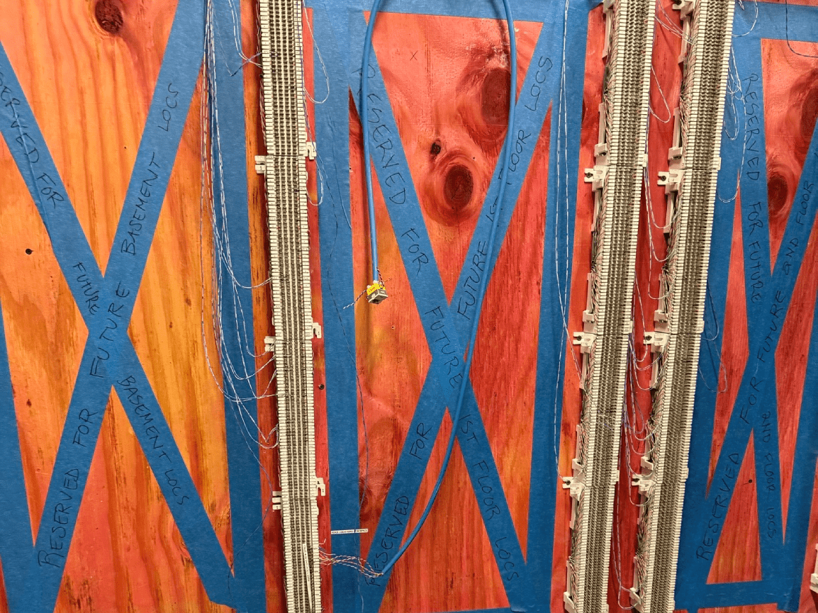 Blue X-braced panels with orange and red sections and metallic vertical strips