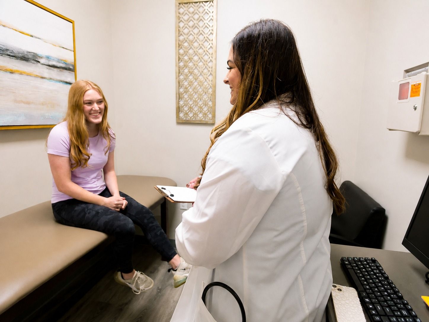 Allyssa Beall, APRN, talking with a patient during a women's health visit
