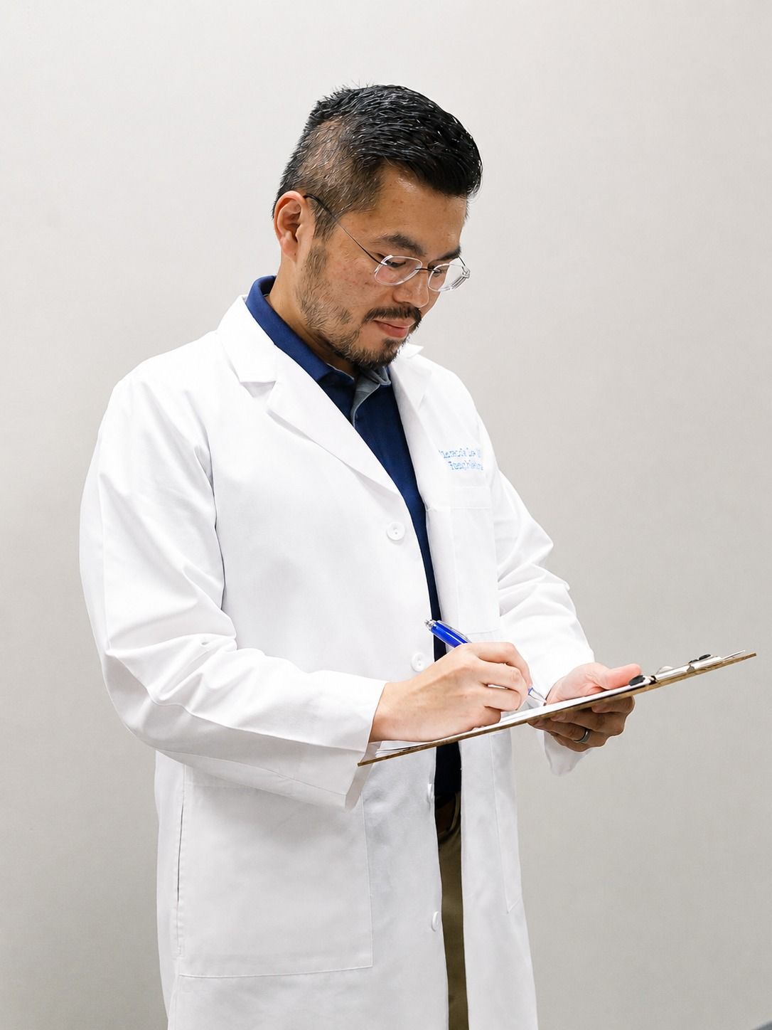 Vincent Lee, MD, reviewing a patient's medical information during an office visit