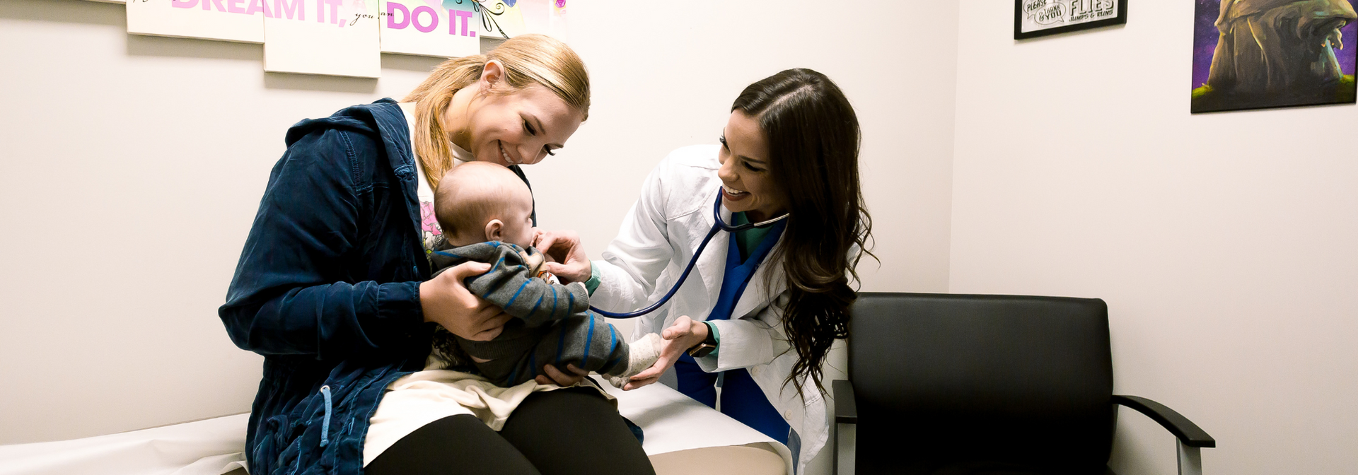 Latoya Coward, APRN examining an infant during a pediatric visit