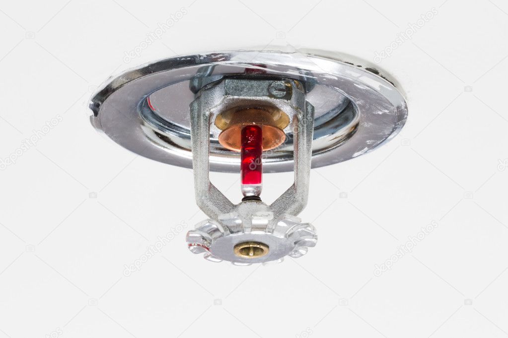 Ceiling-mounted fire sprinkler head with red bulb, silver metal components.