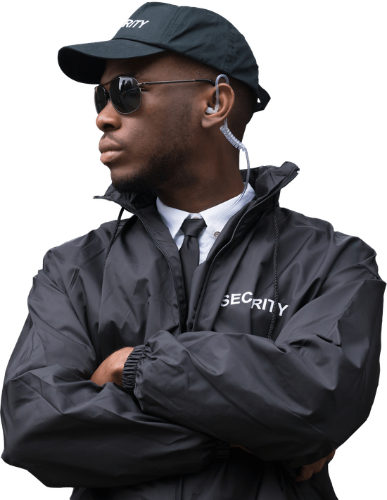 Security guard in black uniform with crossed arms and earpiece.