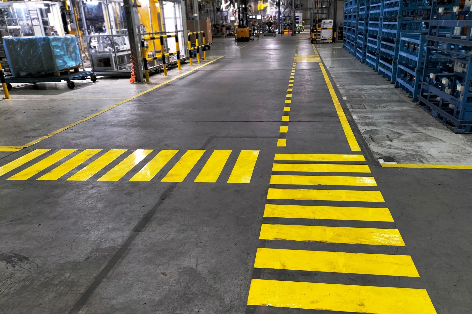 a factory with yellow line markings on the floor