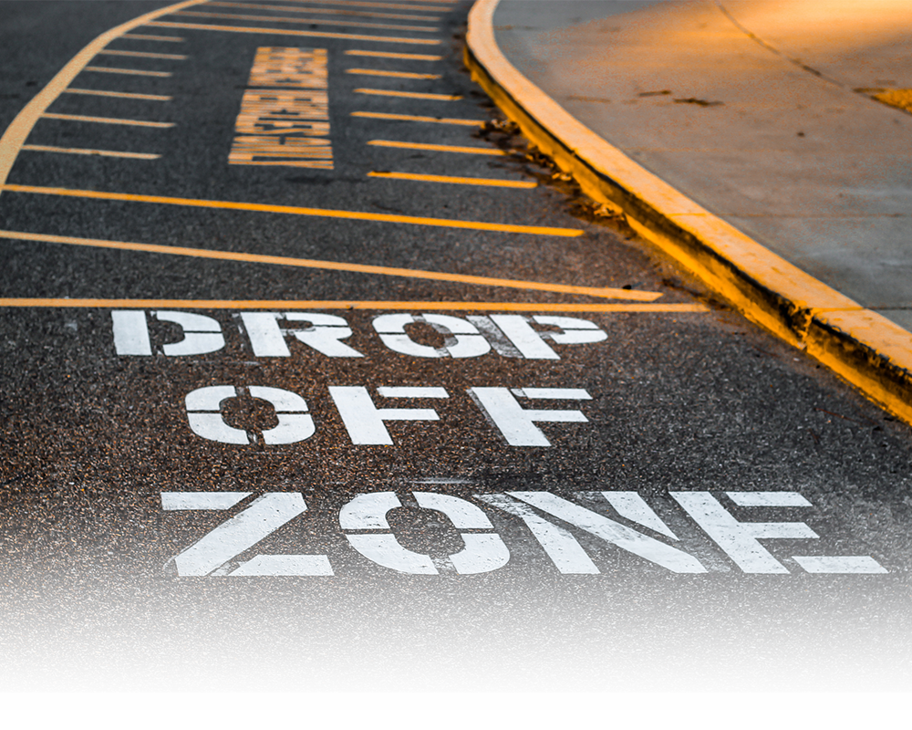 A drop off zone is painted on the side of the road