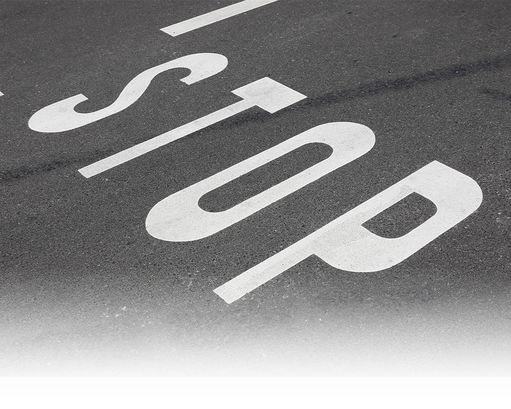 the word stop written on a road