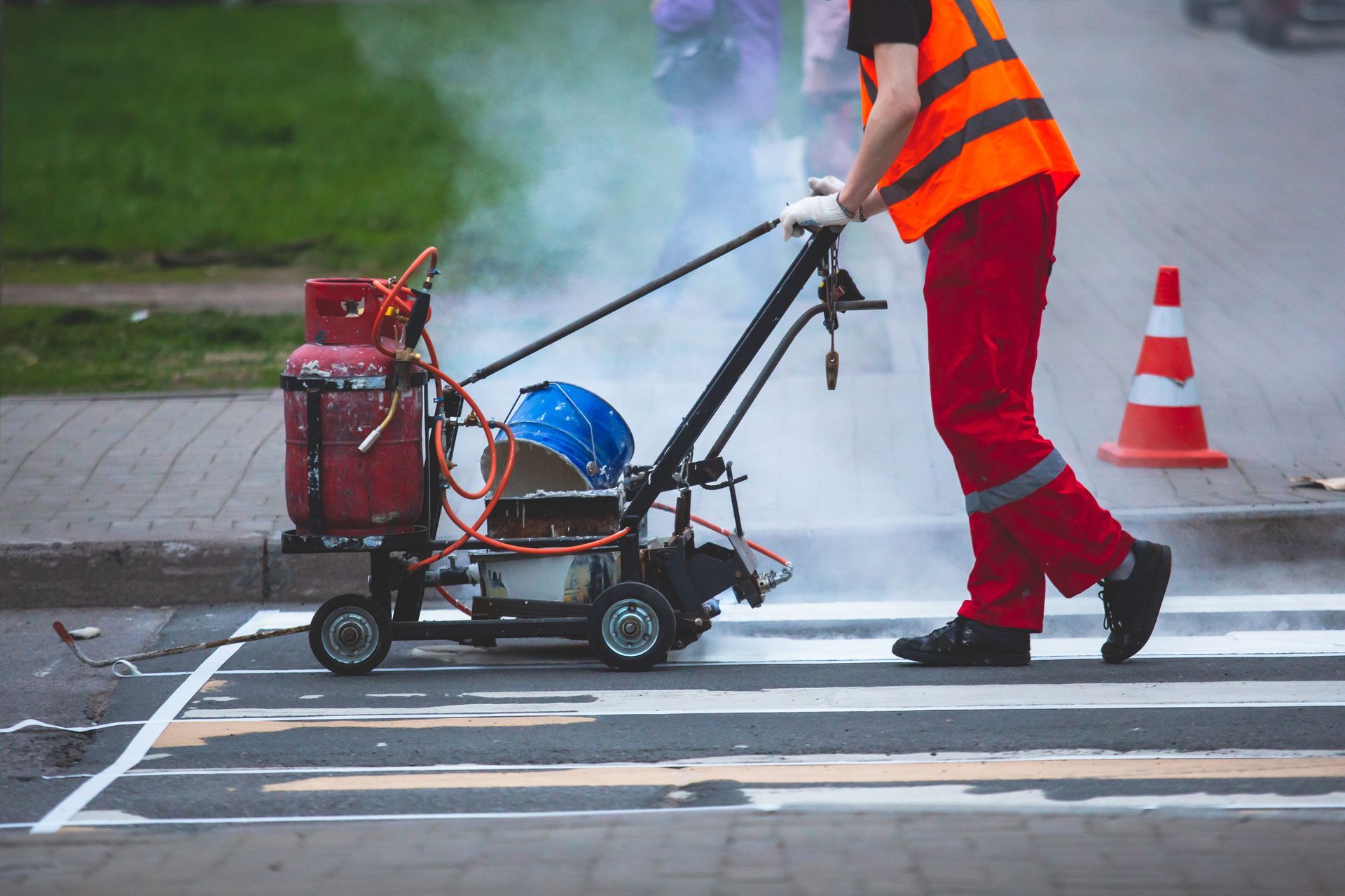 a worker operating a line marking machine
