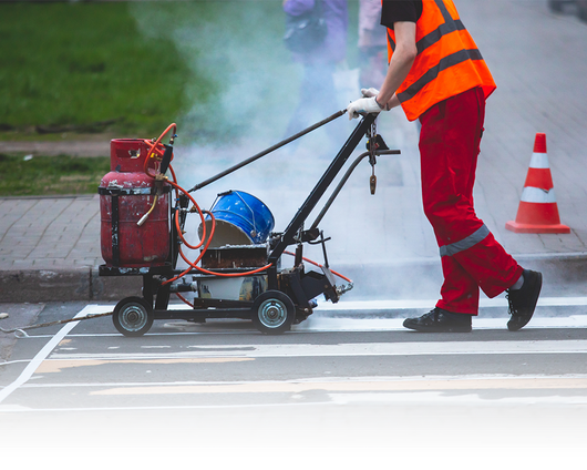 A man operating a line marking machine.