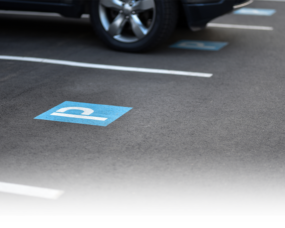 A car is parked in a handicapped parking spot