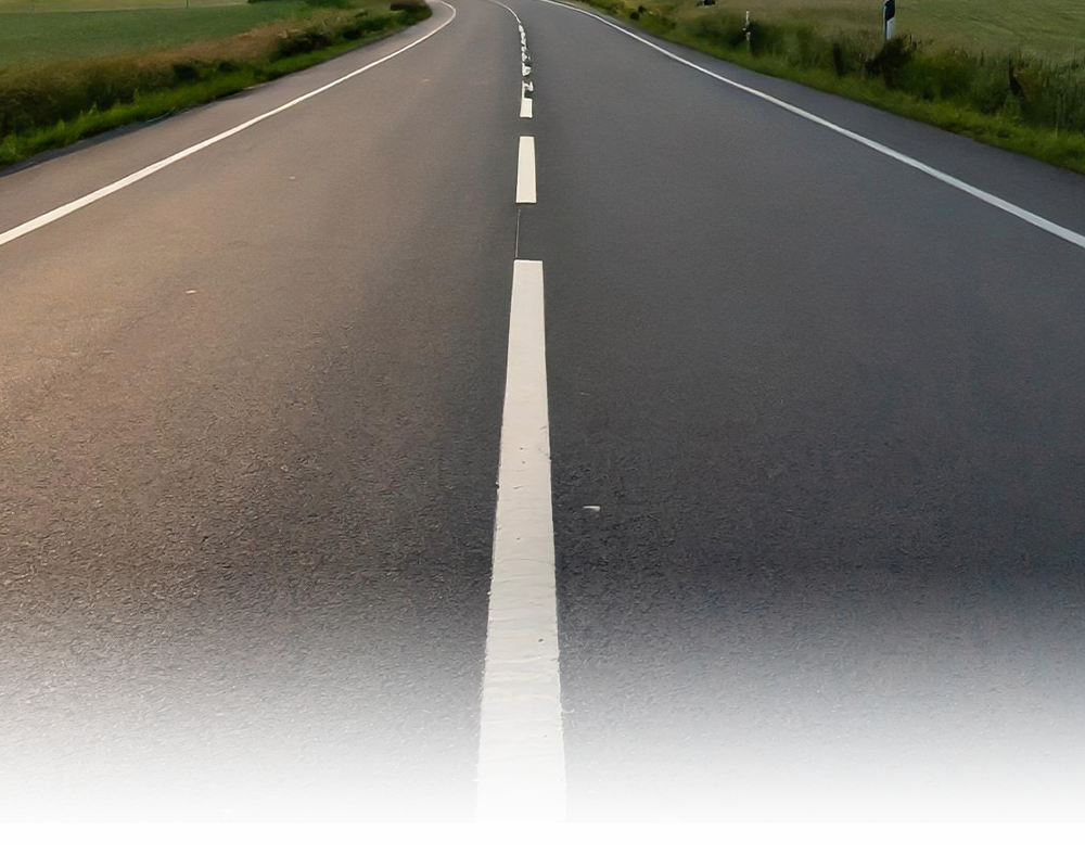 A road with a white line in the middle of it.