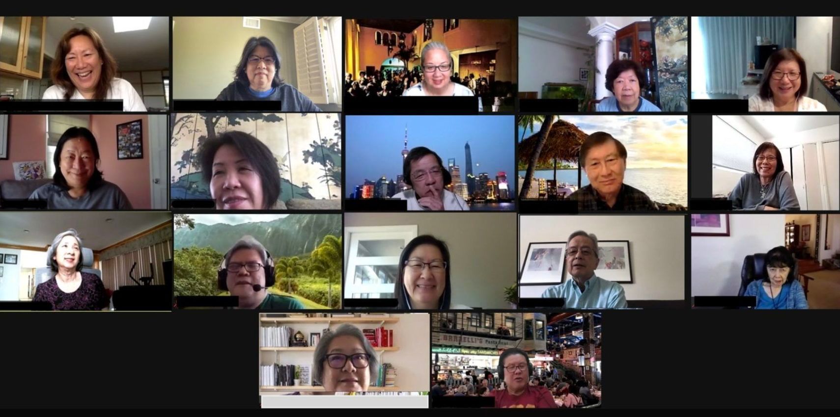 A video conference call with 18 people; all smiling.