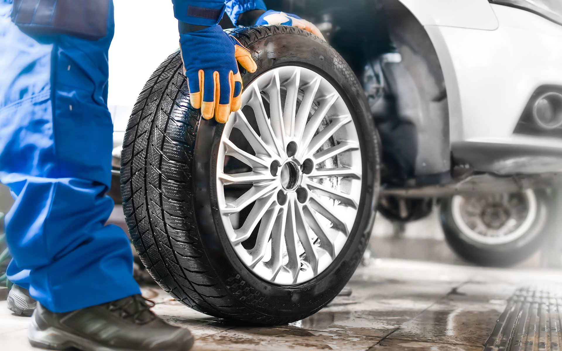 A person is changing a tire on a car.