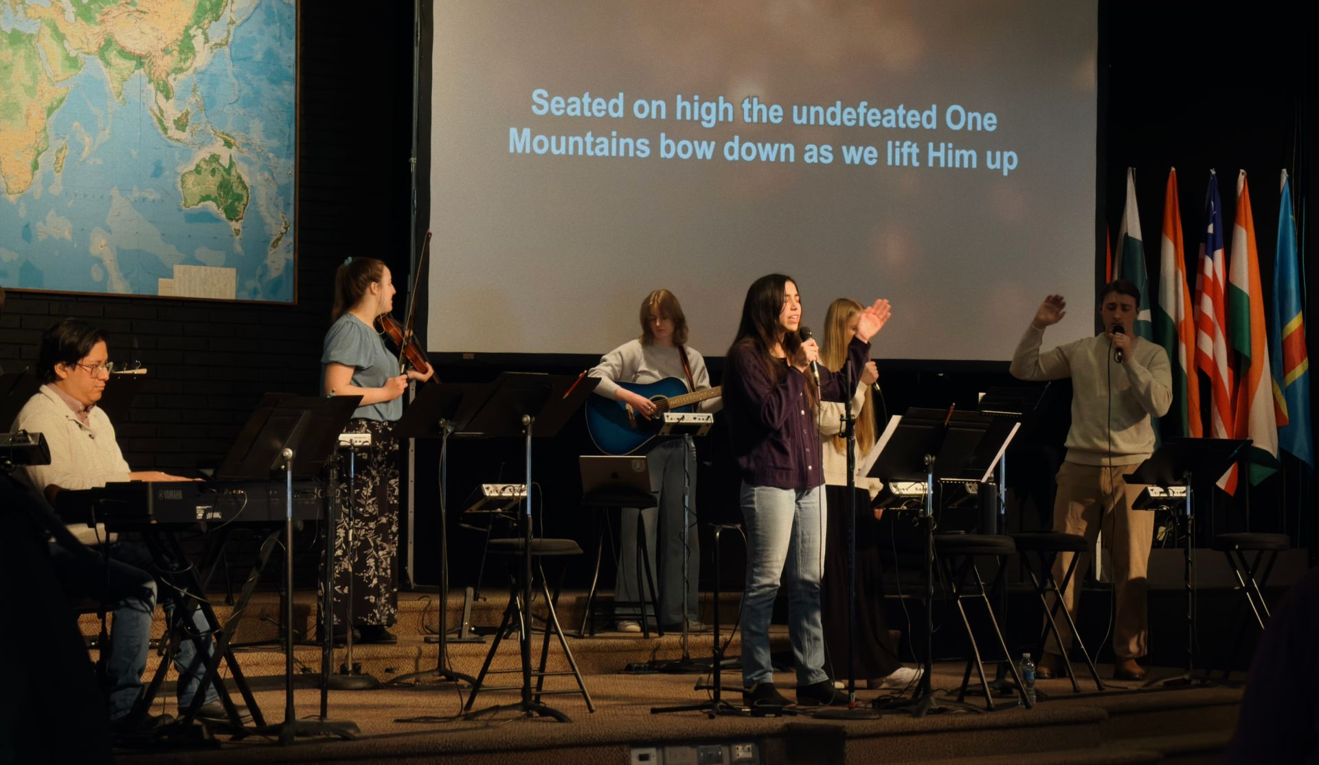 a student leading worship during chapel
