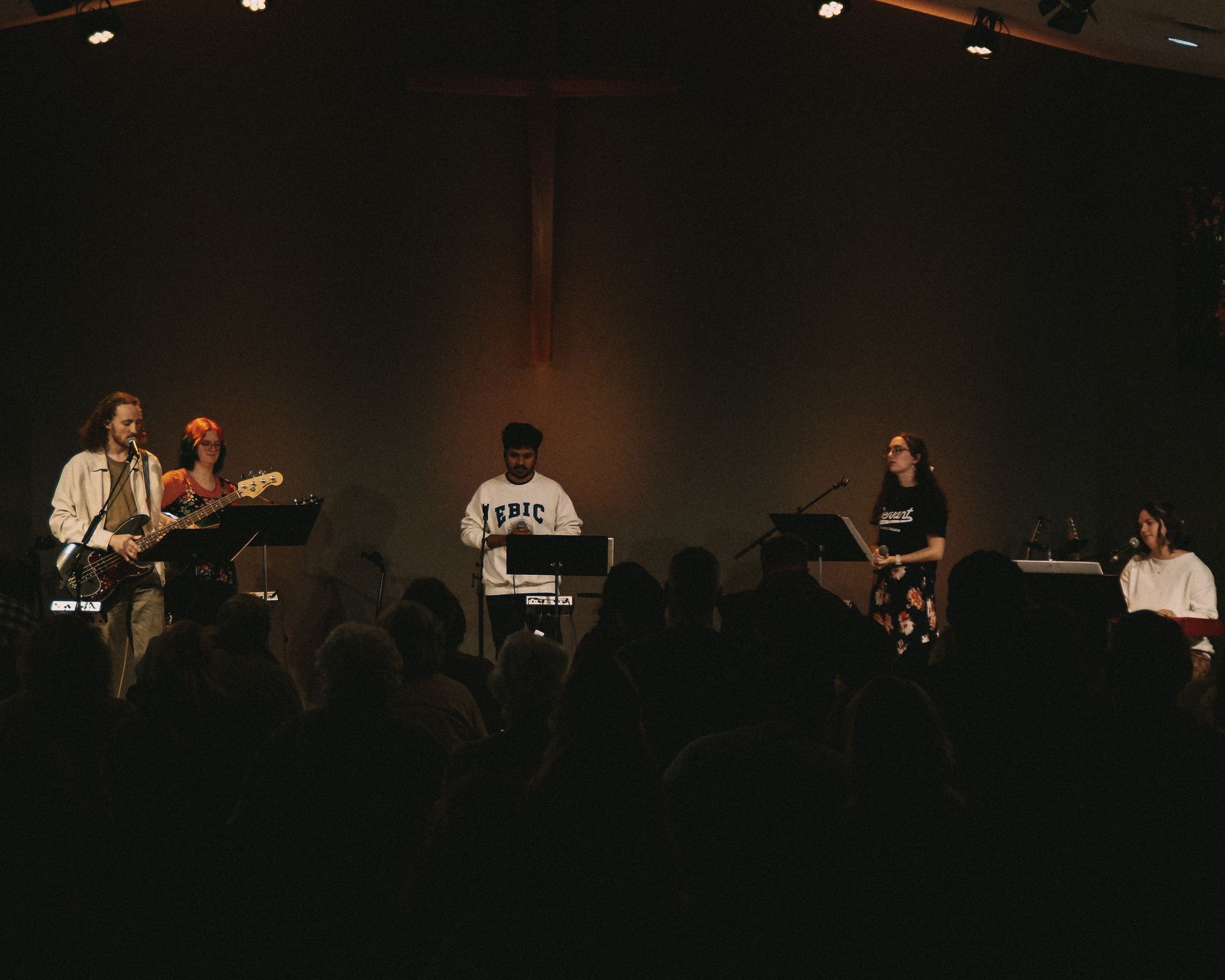 students worshipping on stage at a church