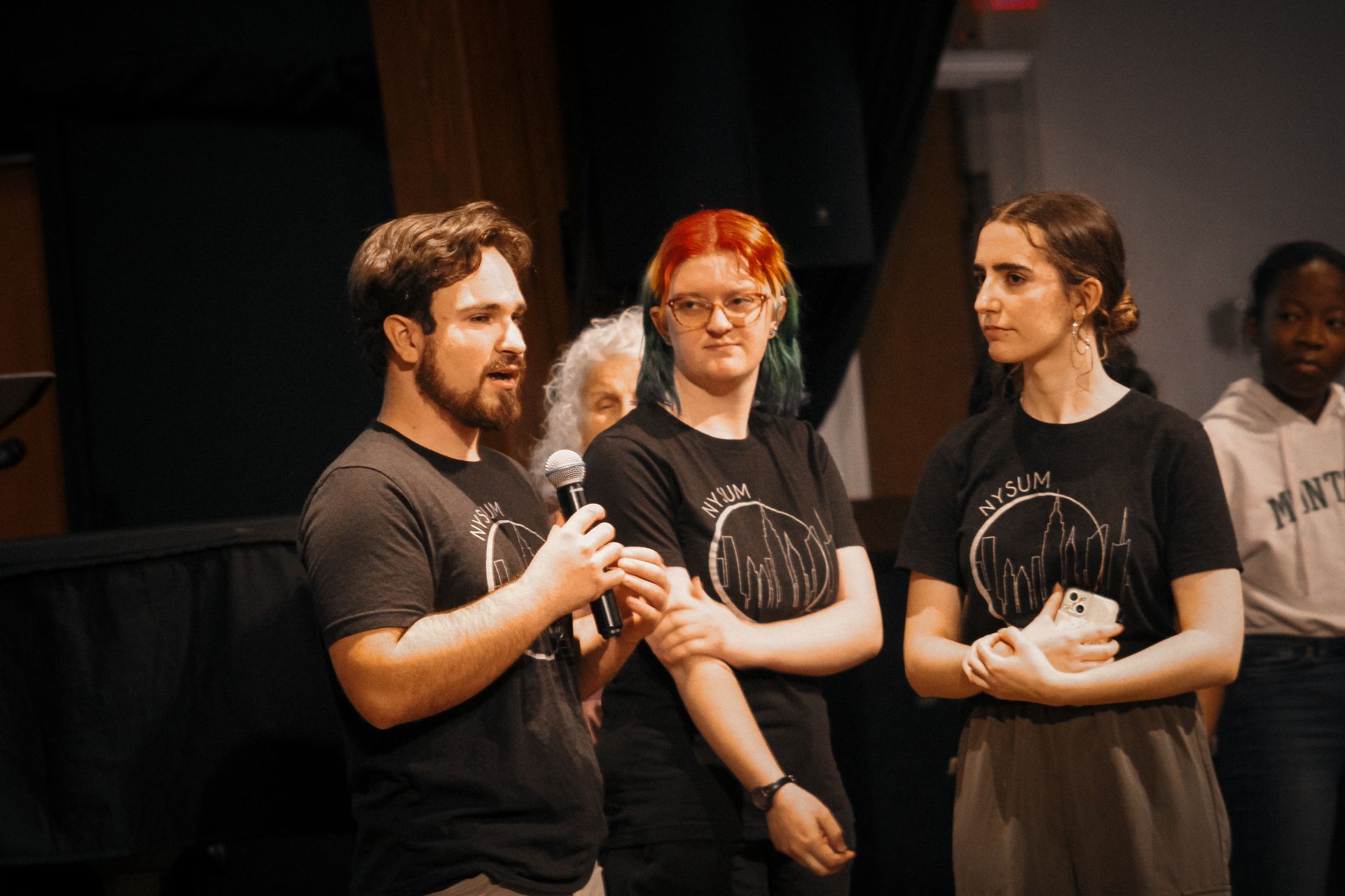 three students speaking during a chapel service