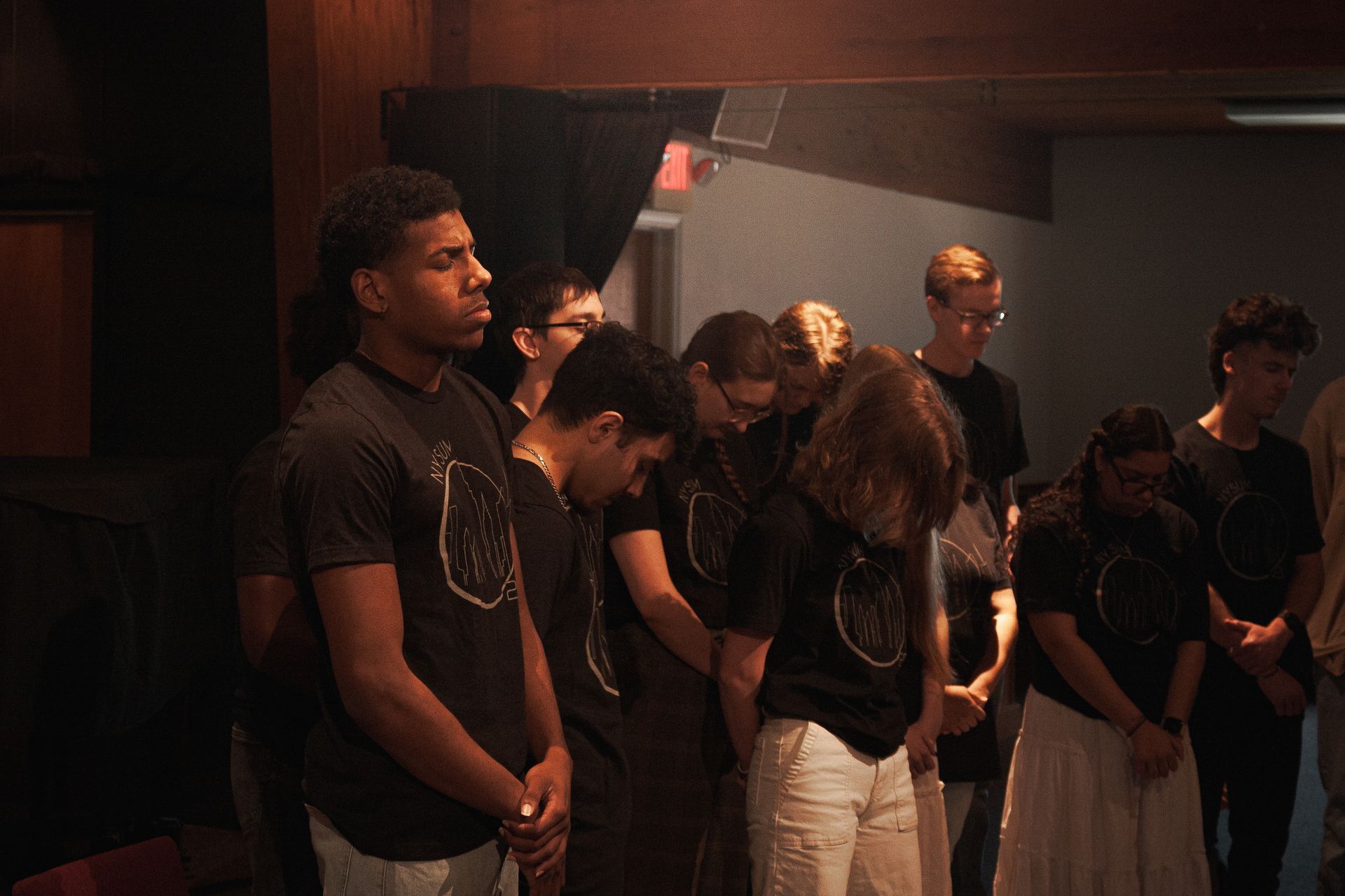 three students speaking during a chapel service
