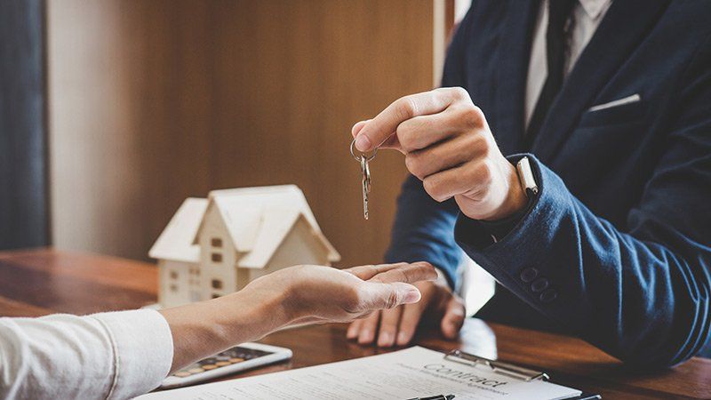 one person hands keys to another person