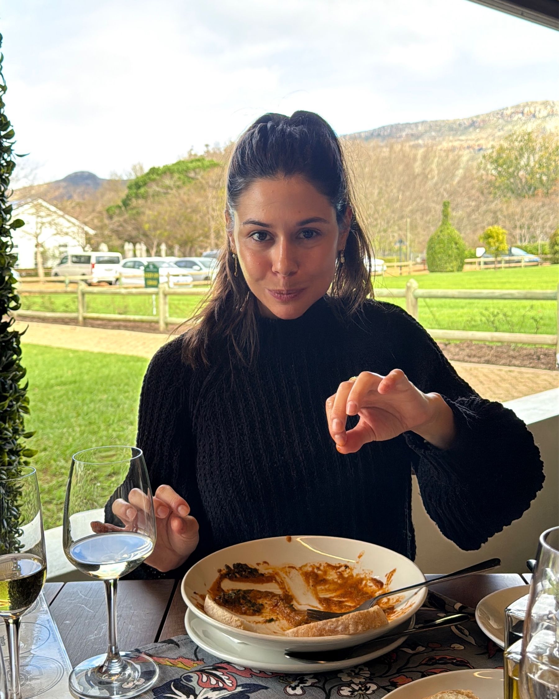 Paige is enjoying seafood pasta and wine at Chardonnay Deli Uitsig
