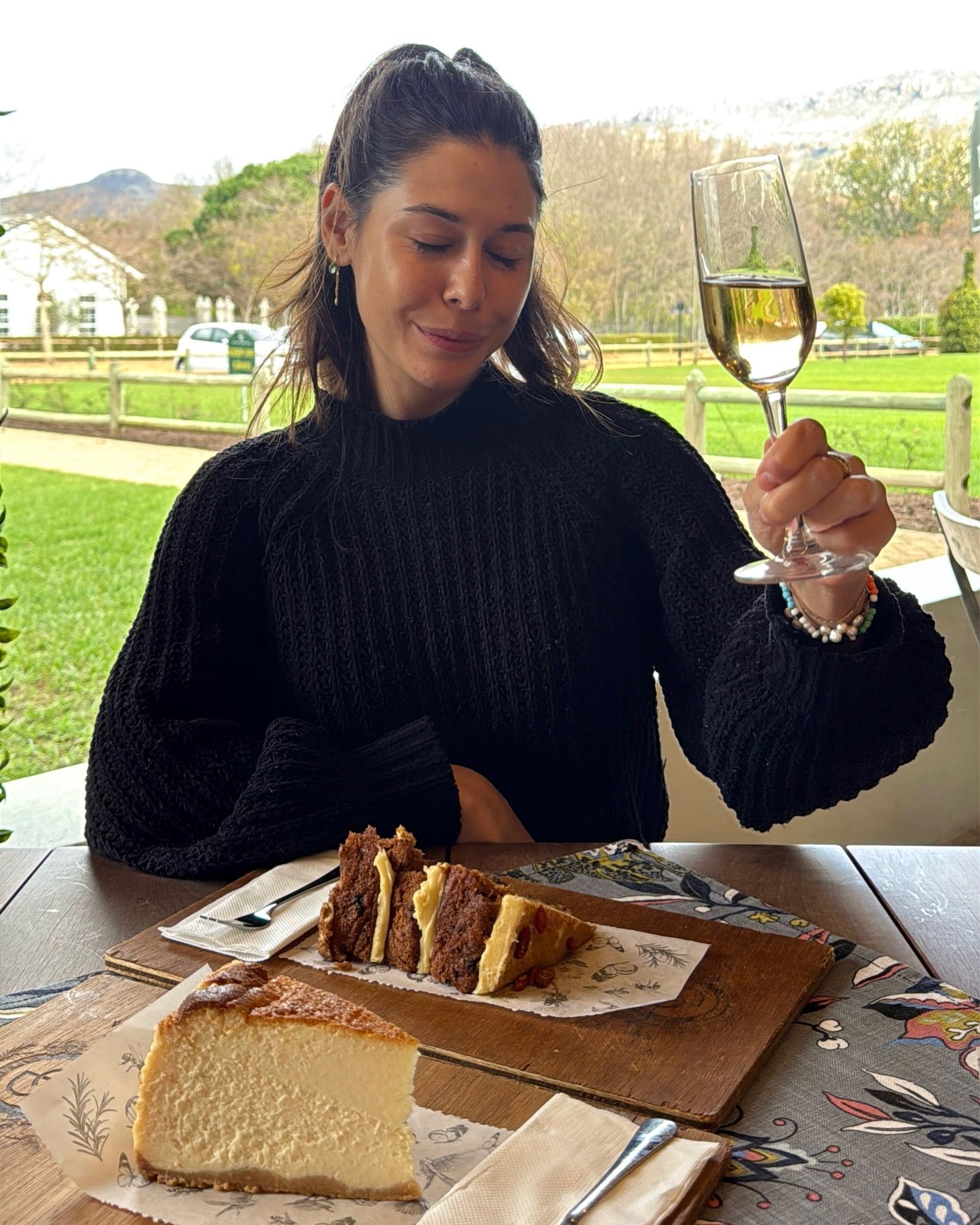 Paige is enjoying cake and bubbles at Chardonnay Deli Uitsig

