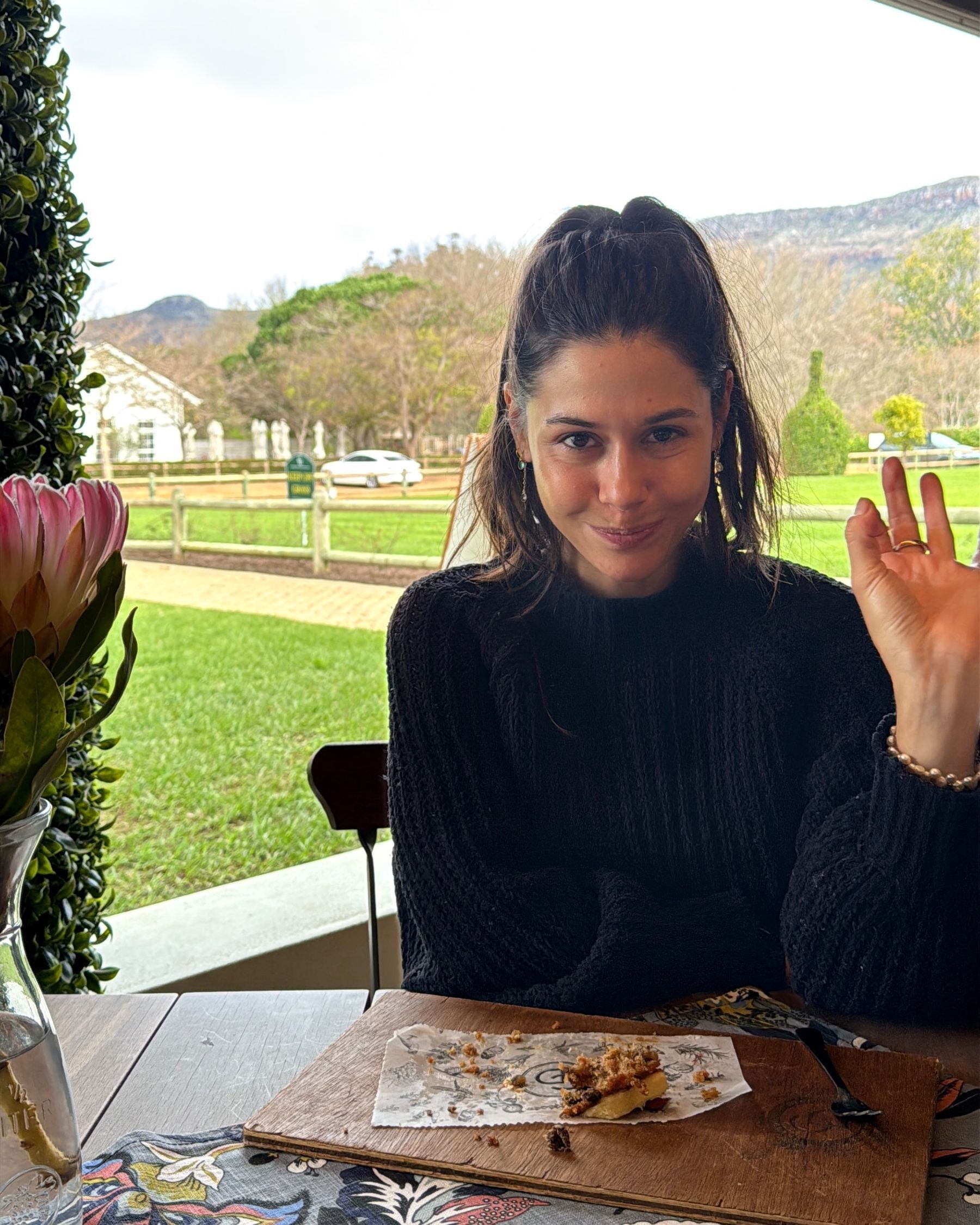 Paige is enjoying cake and bubbles at Chardonnay Deli Uitsig
