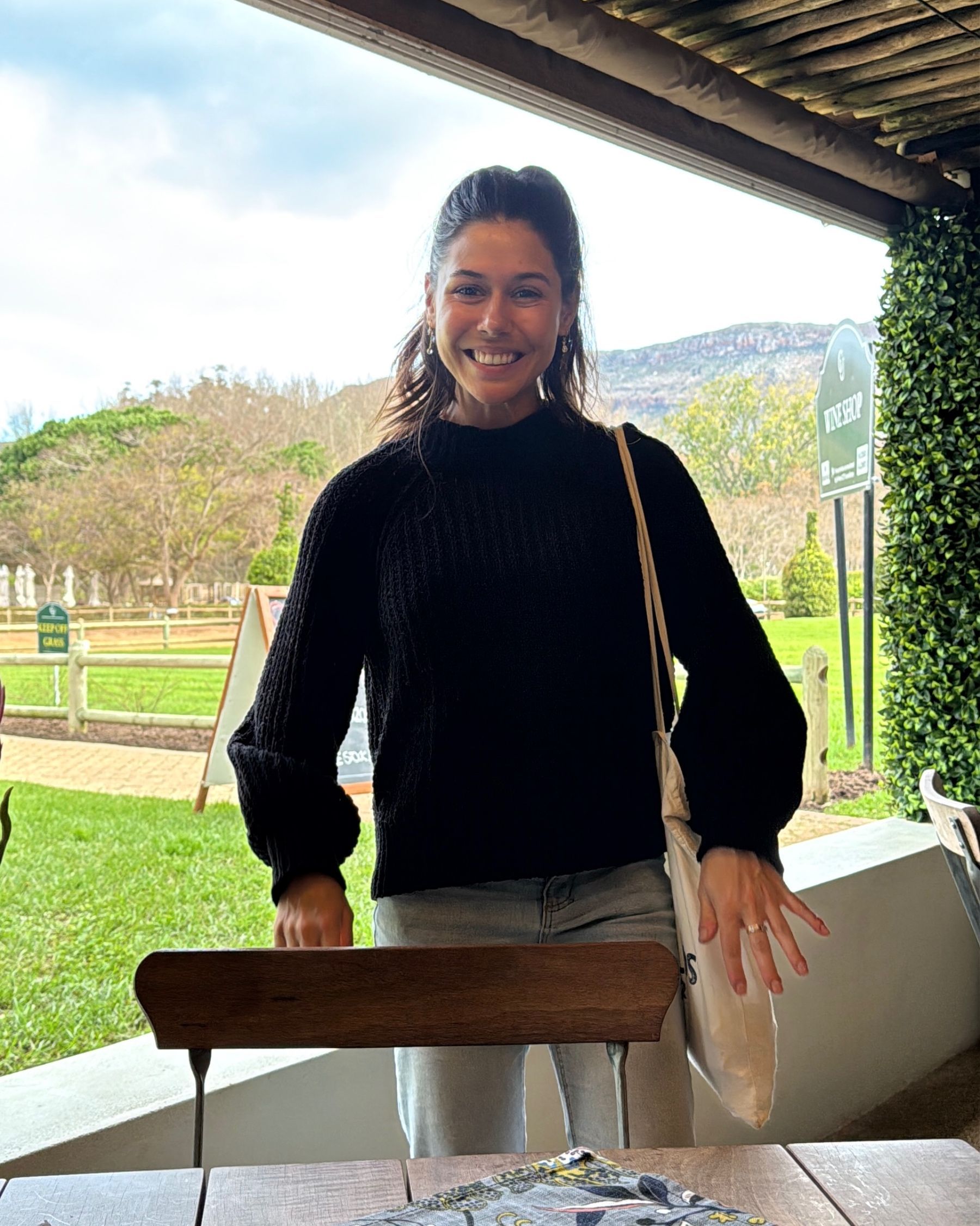 Paige is smiling before sitting down at Chardonnay Deli Uitsig
