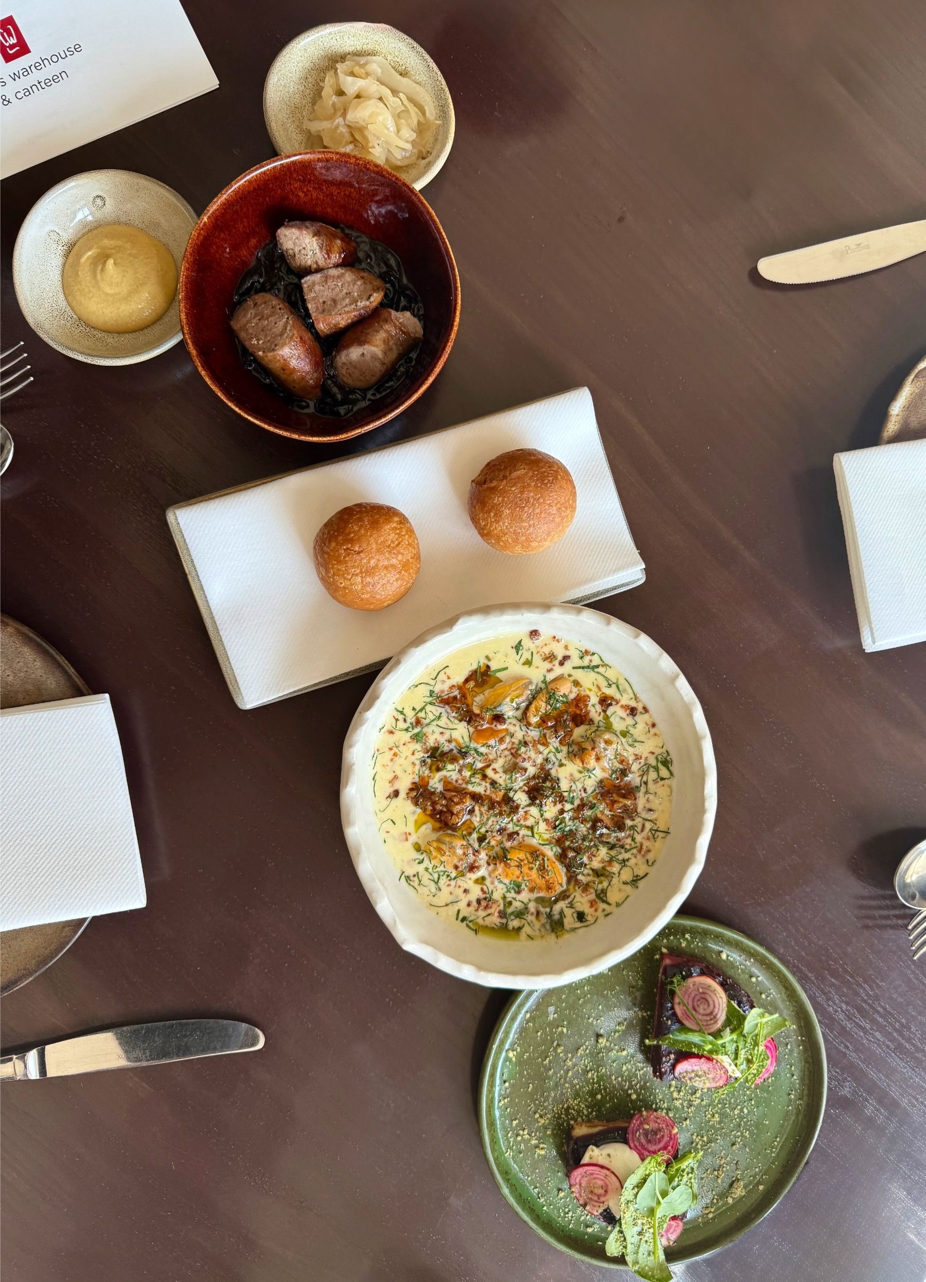 Overhead view of starters at Chefs Warehouse & Canteen including seafood and seasonal small plates.