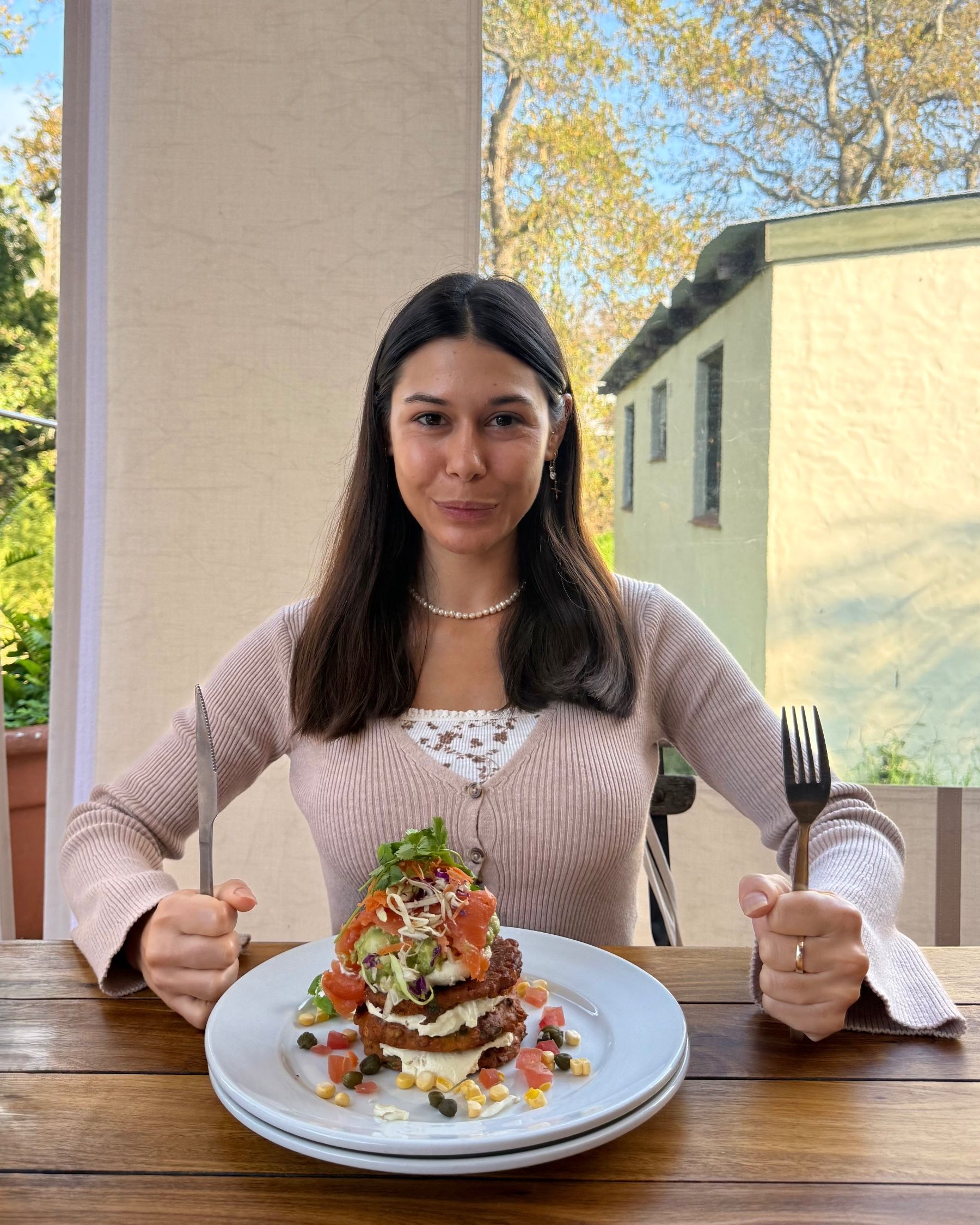 Paige enjoying sweet corn fritters at Chardonnay Deli High Constantia
