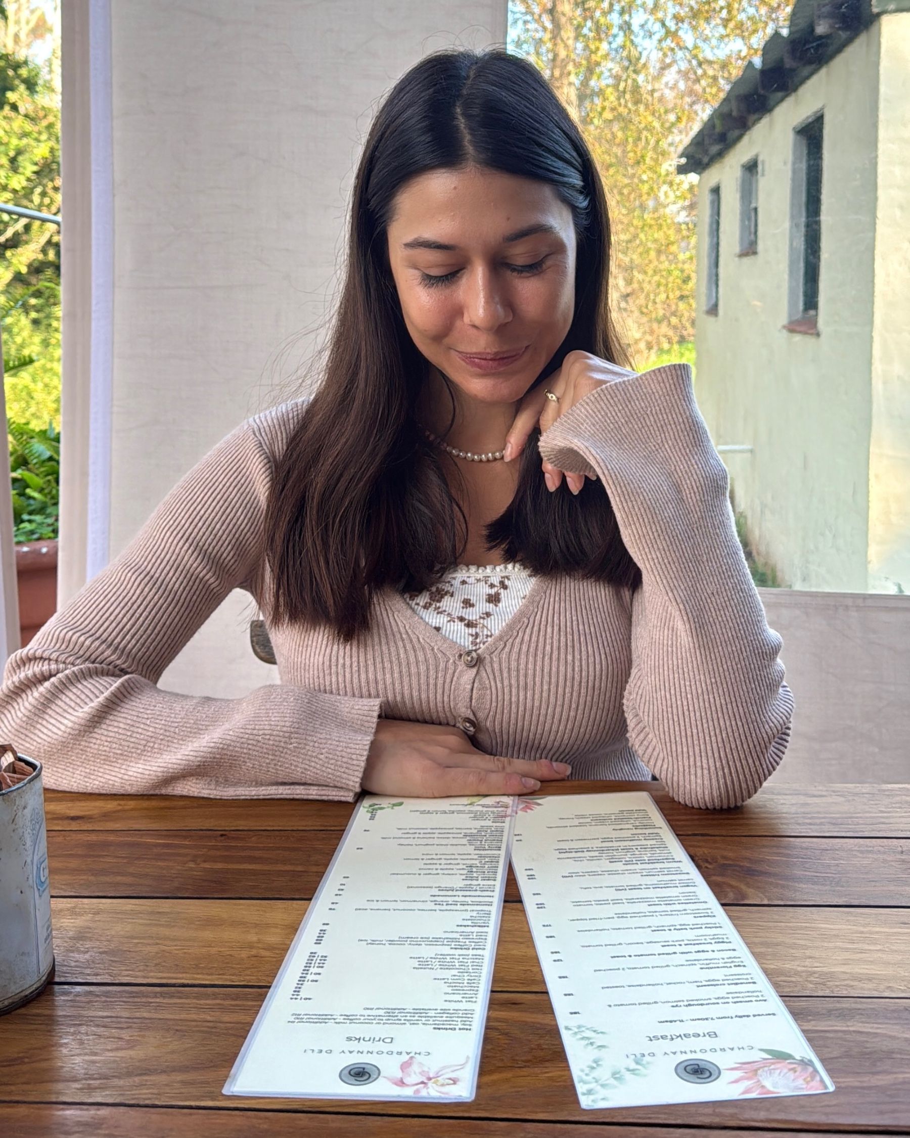 Paige reading the menu at Chardonnay Deli High Constantia
