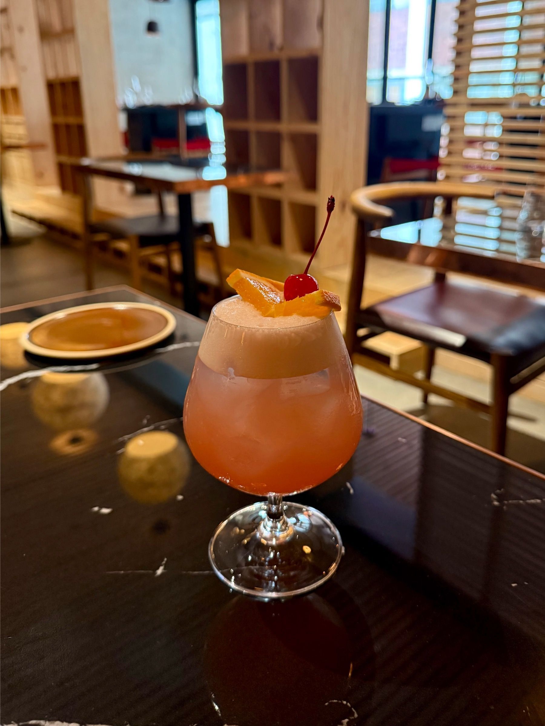 East City Grill’s Singapore Sling-inspired cocktail with blush foam, orange slice and cherry