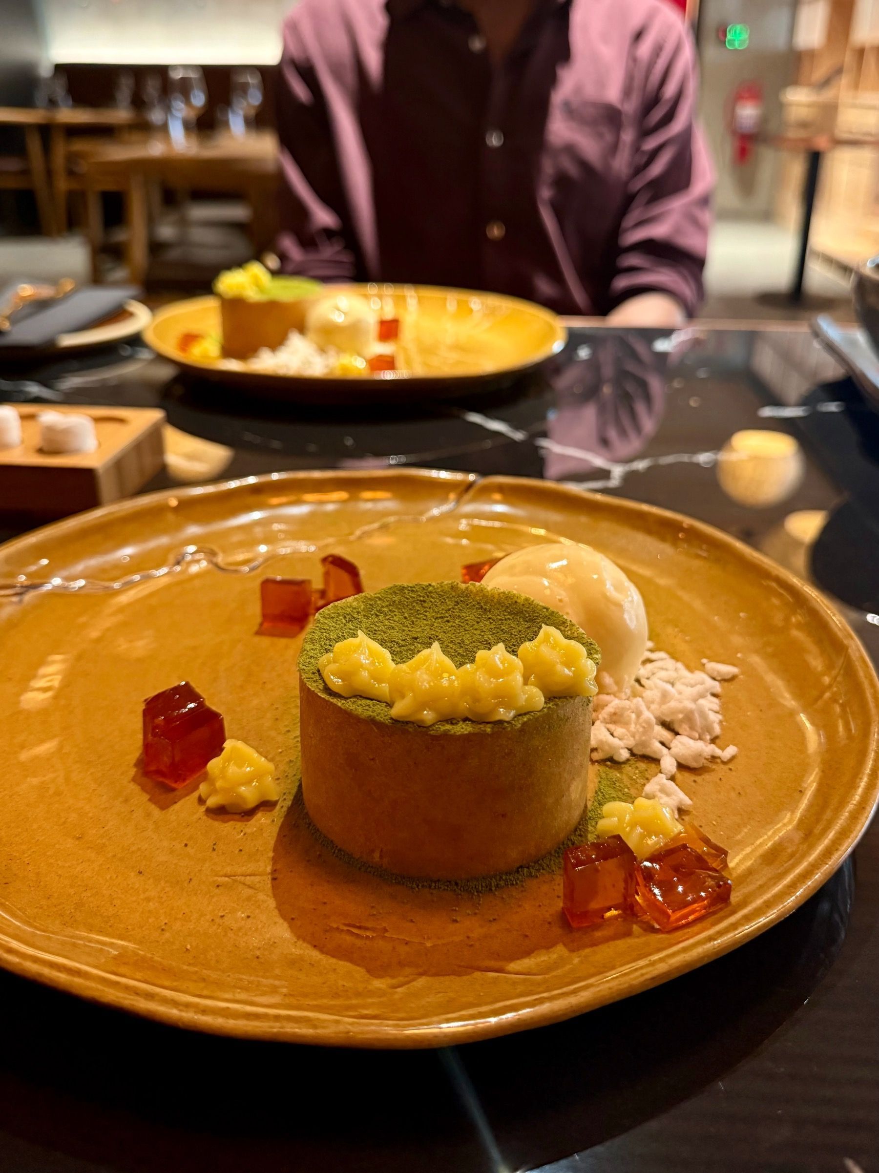 East City Grill cheesecake with tennis biscuit base, matcha dusting and puffed rice ice cream