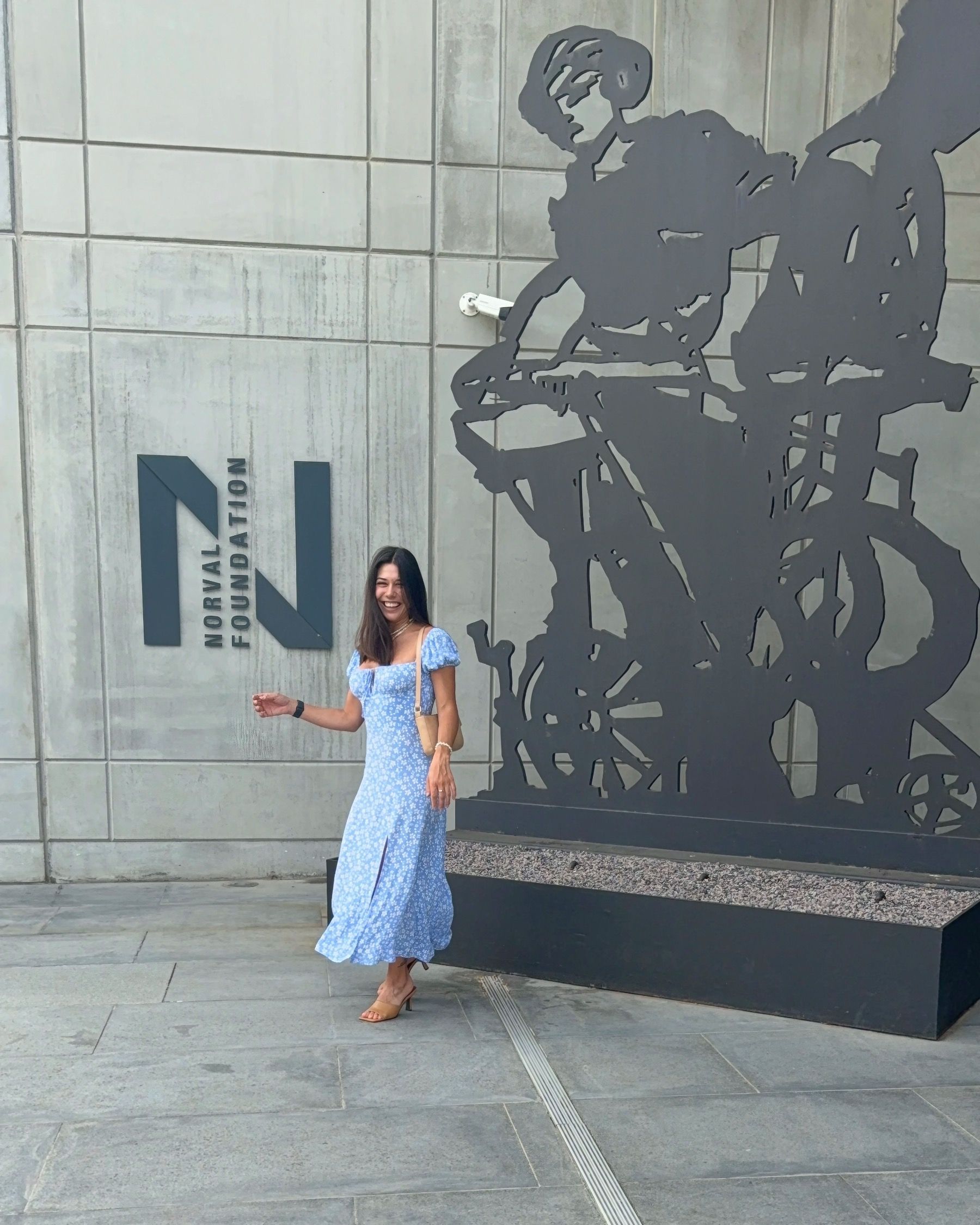 Paige Ellis Green standing by the Norval Foundation sculpture garden sign at Grub & Vine Norval