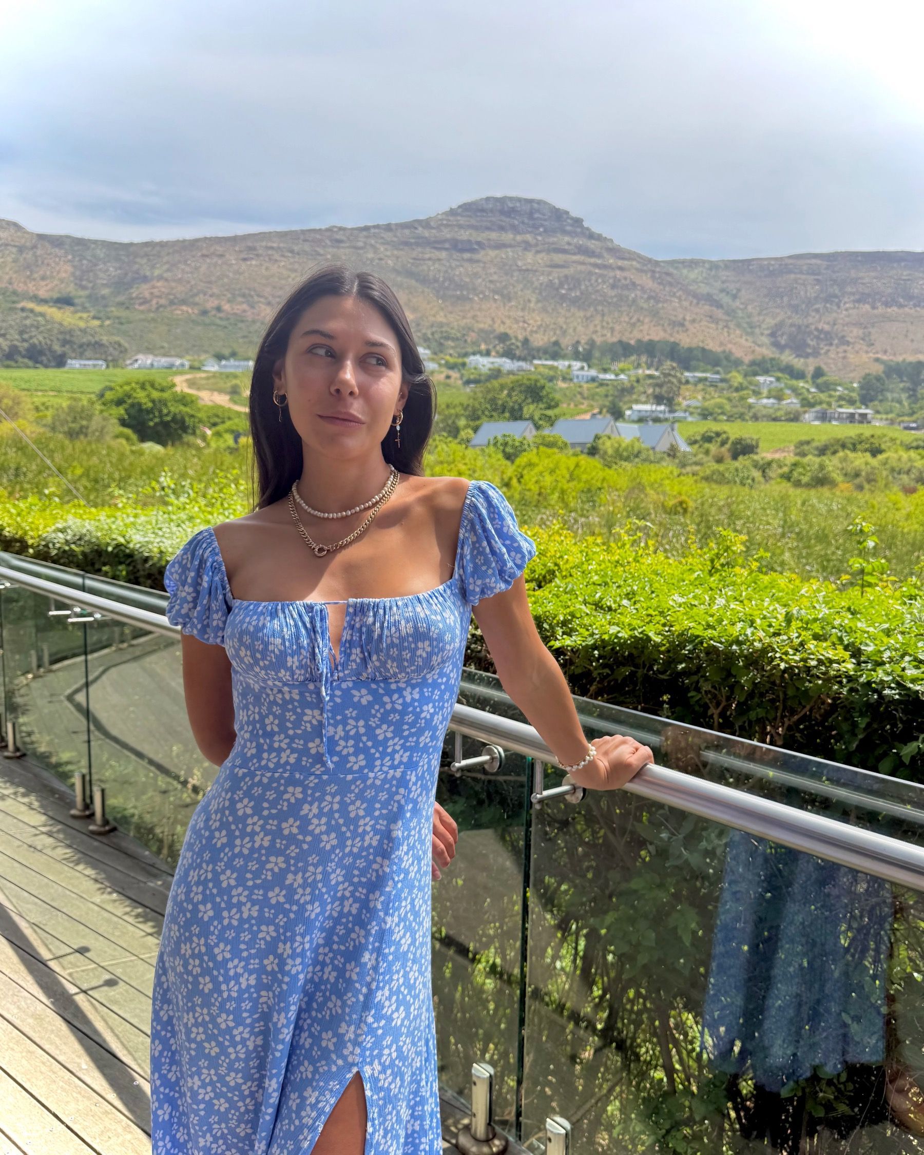 Paige Ellis Green posing on Grub & Vine Norval terrace overlooking Norval sculpture garden and mountains