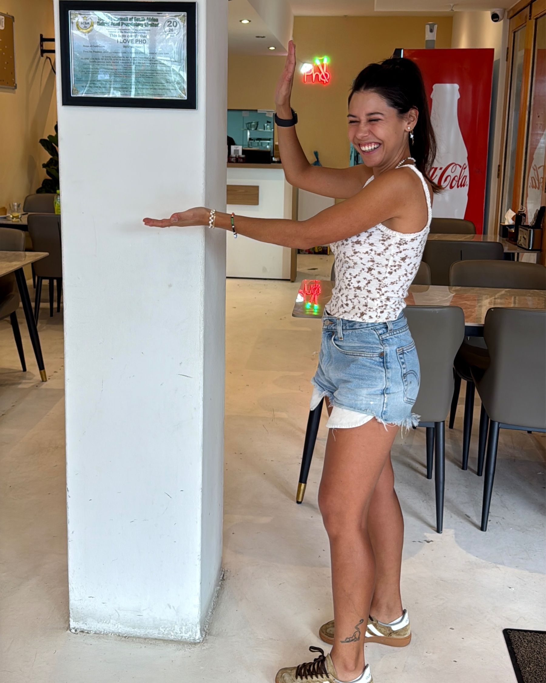 Paige next to halaal certified sign at I Love Pho