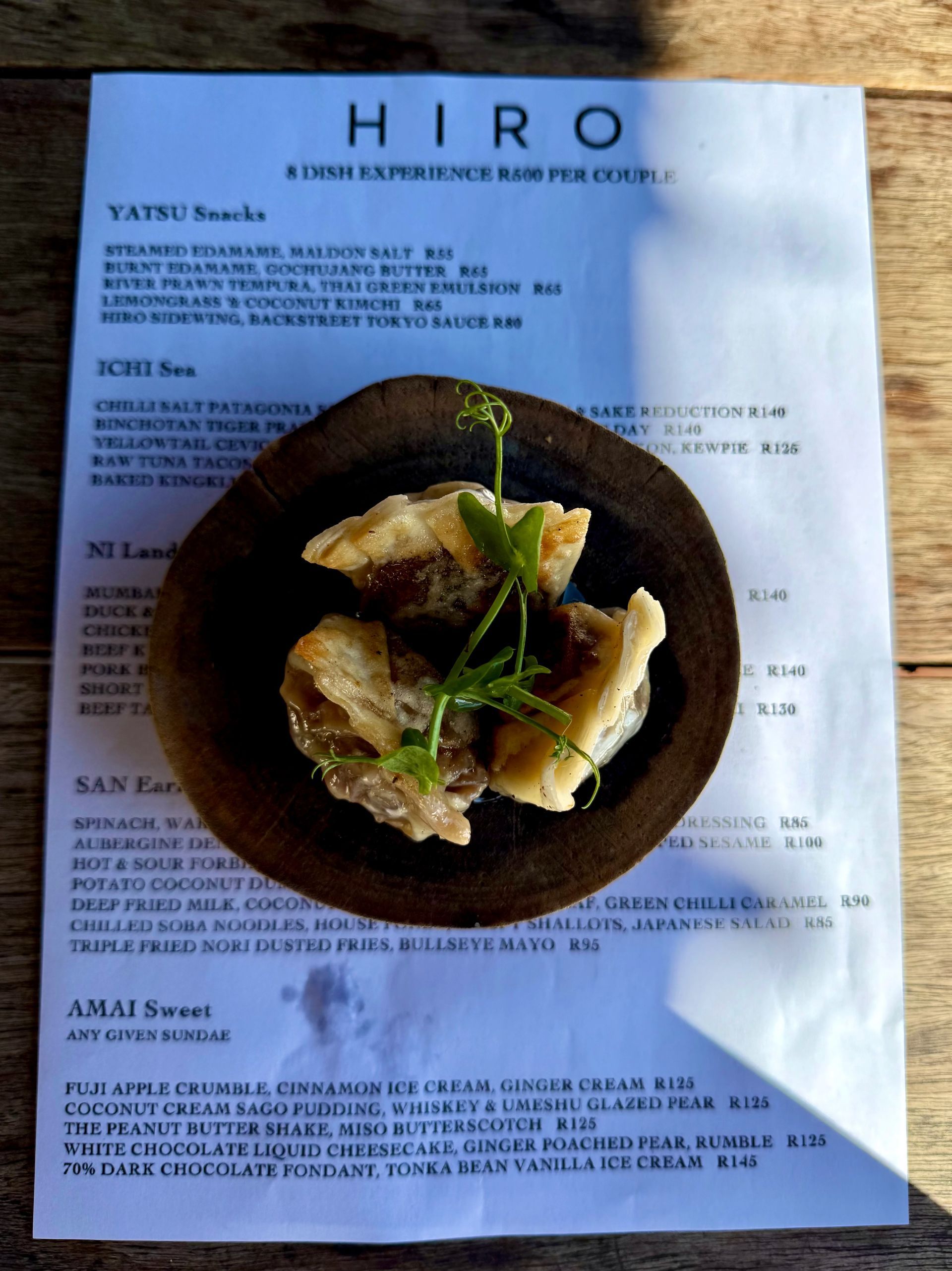 Menu and food, brown wooden plate with crispy fried food, Hiro restaurant.