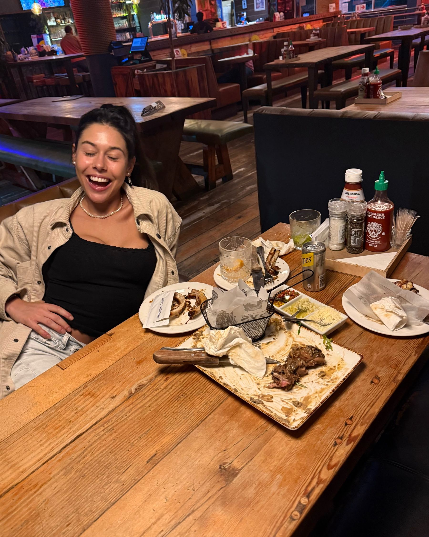 Paige sitting with empty plates after her meal at Jerry’s
