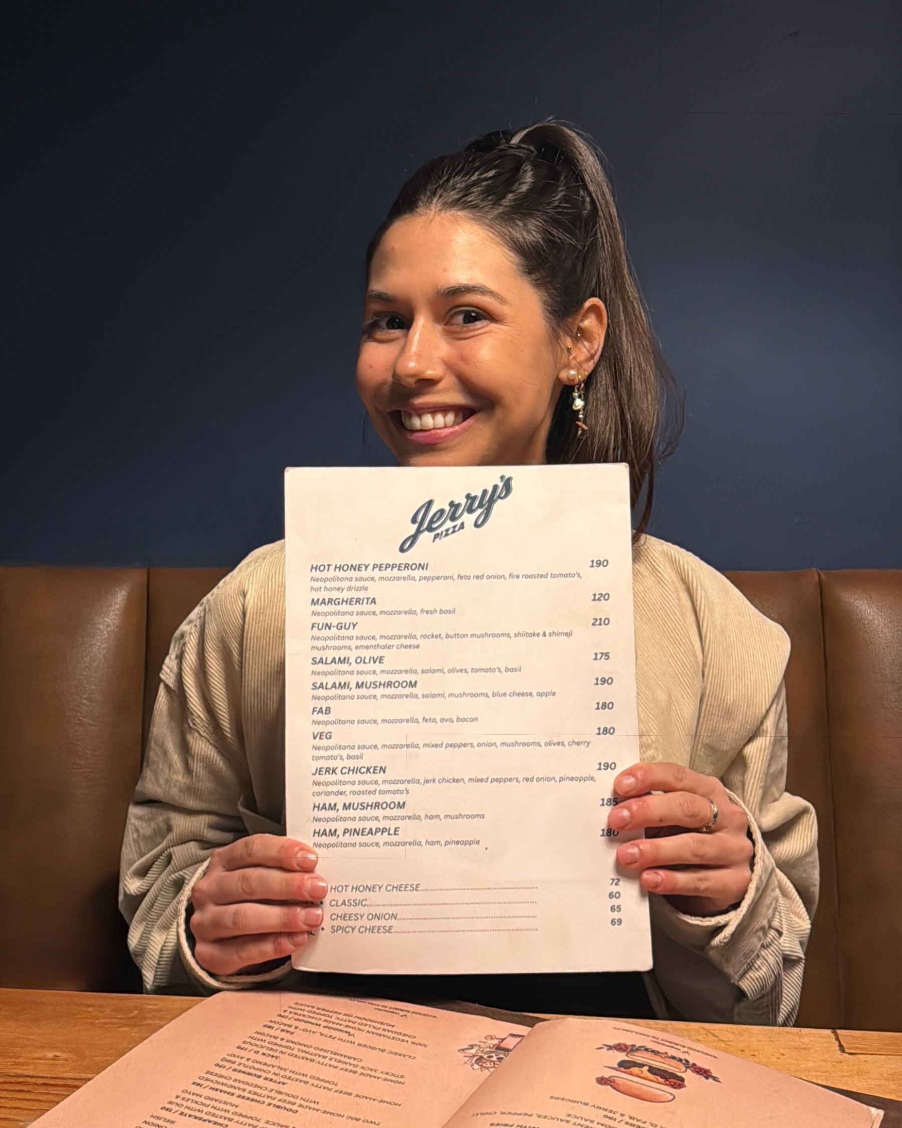 Paige holding the menu at Jerry’s Blouberg

