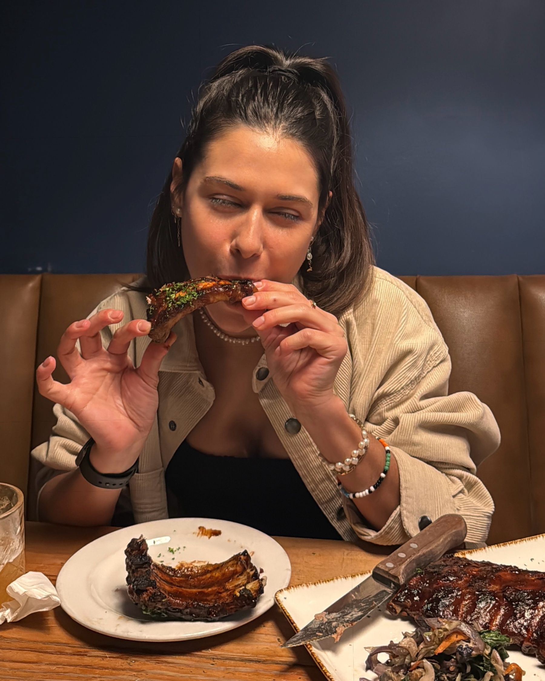 Paige eating sticky pork ribs at Jerry’s
