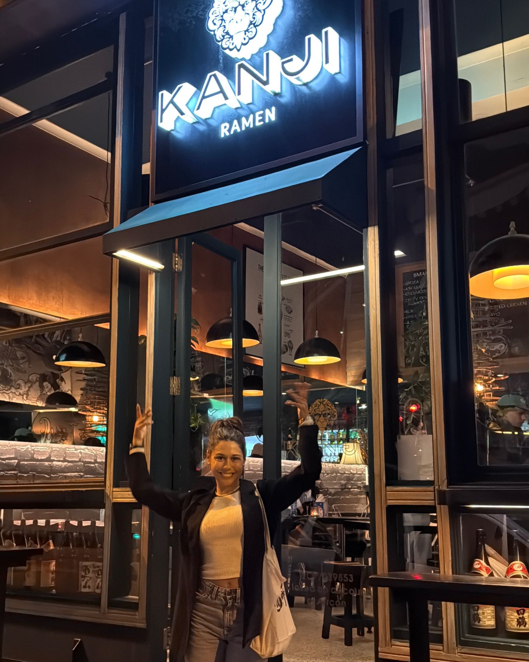 Paige standing at Kanji Ramen exterior and entrance in Cape Town