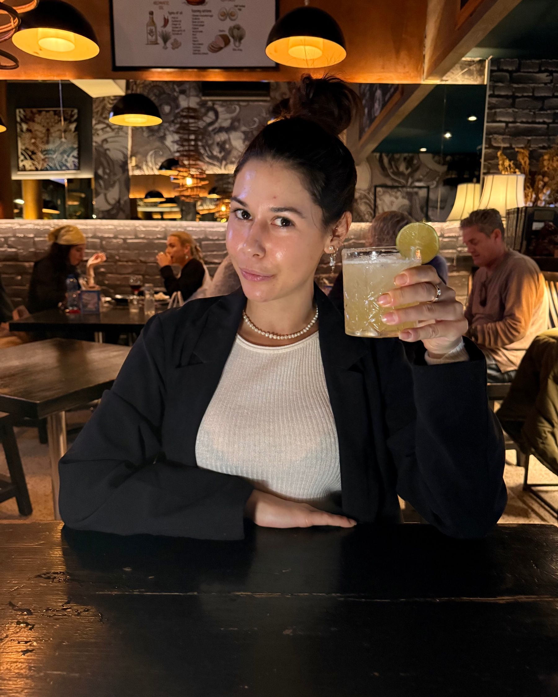 Paige is drinking a yuzu margarita at Kanji Ramen