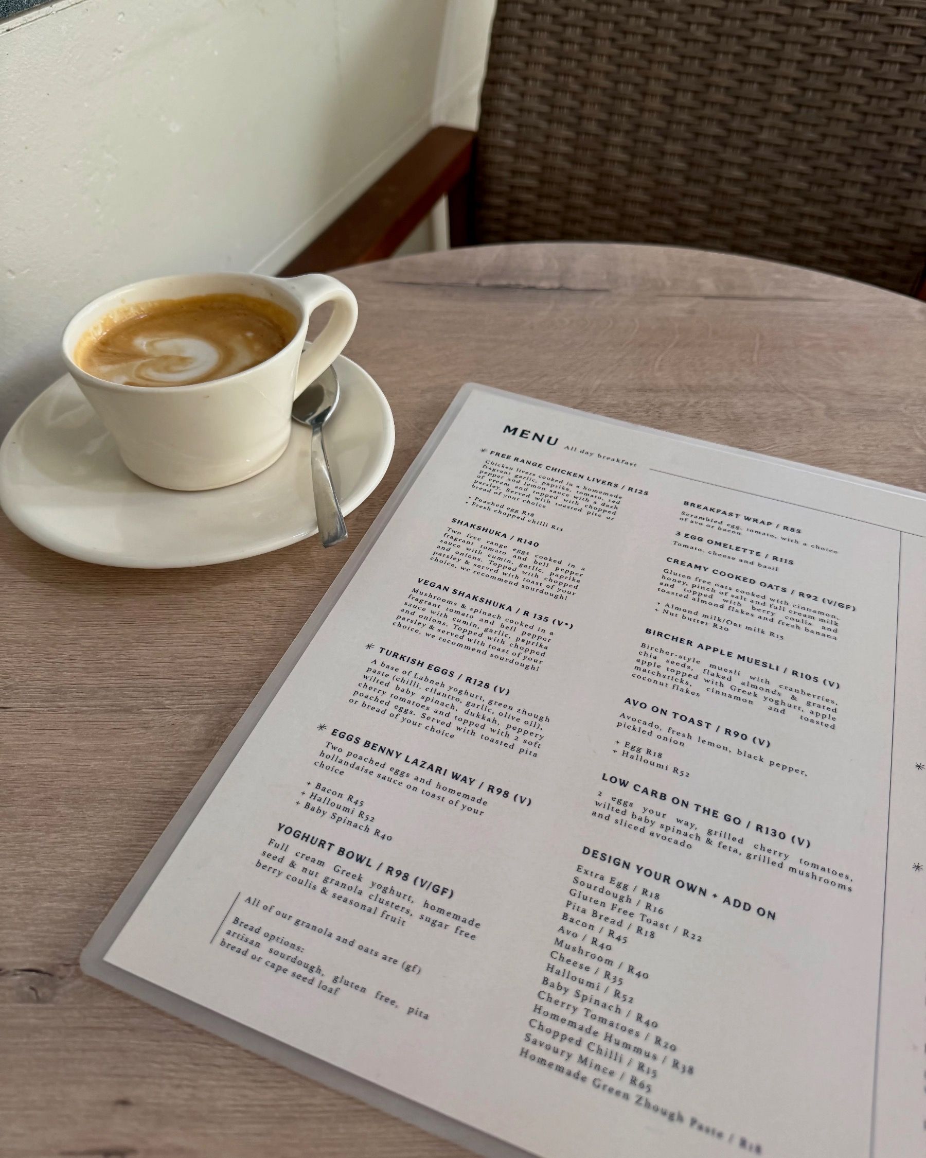 Lazari Café menu with a cortado coffee on the table during a relaxed brunch in Gardens, Cape Town