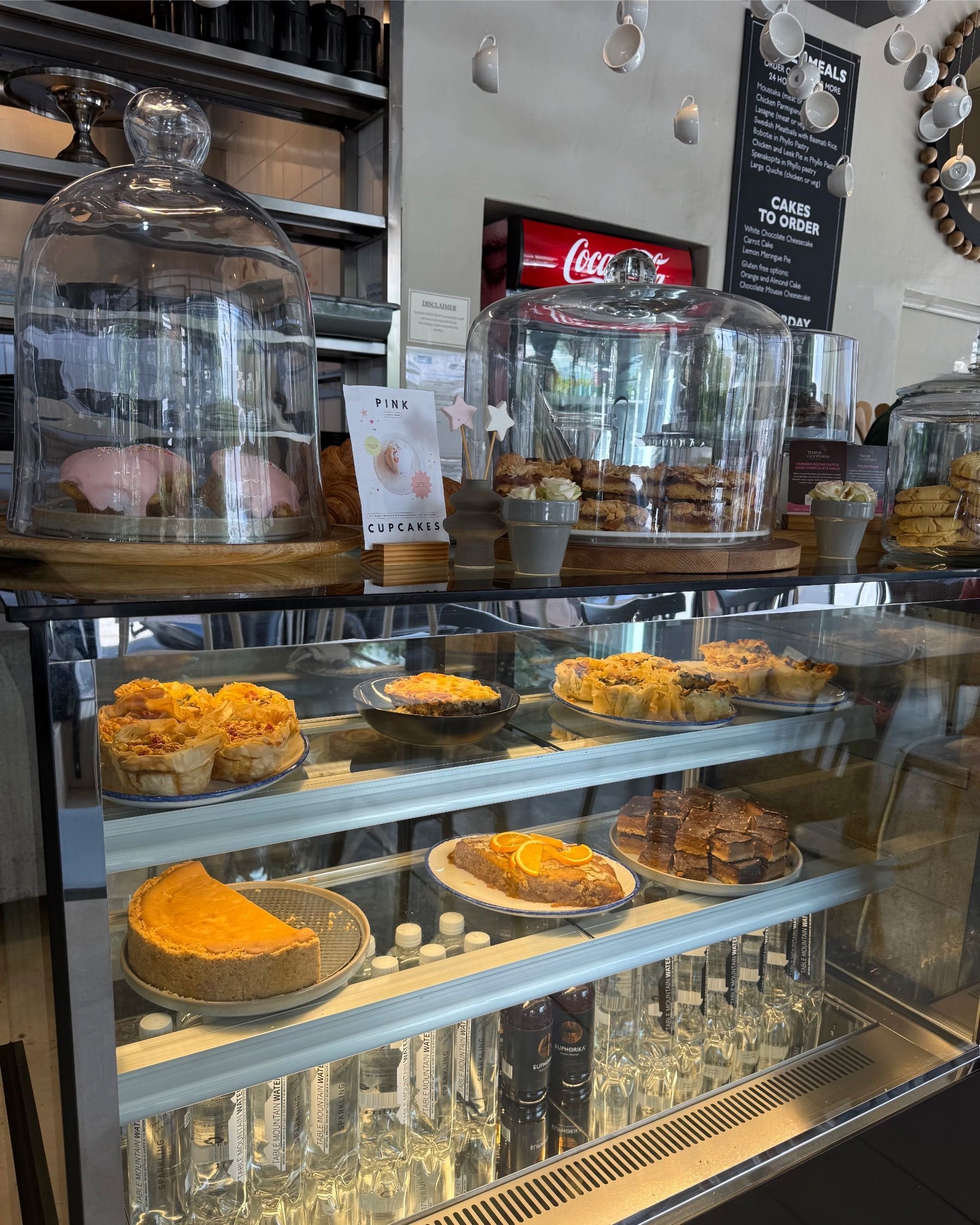 Selection of baked goods at Lazari Café including cakes and pastries displayed in the counter in Gardens, Cape Town