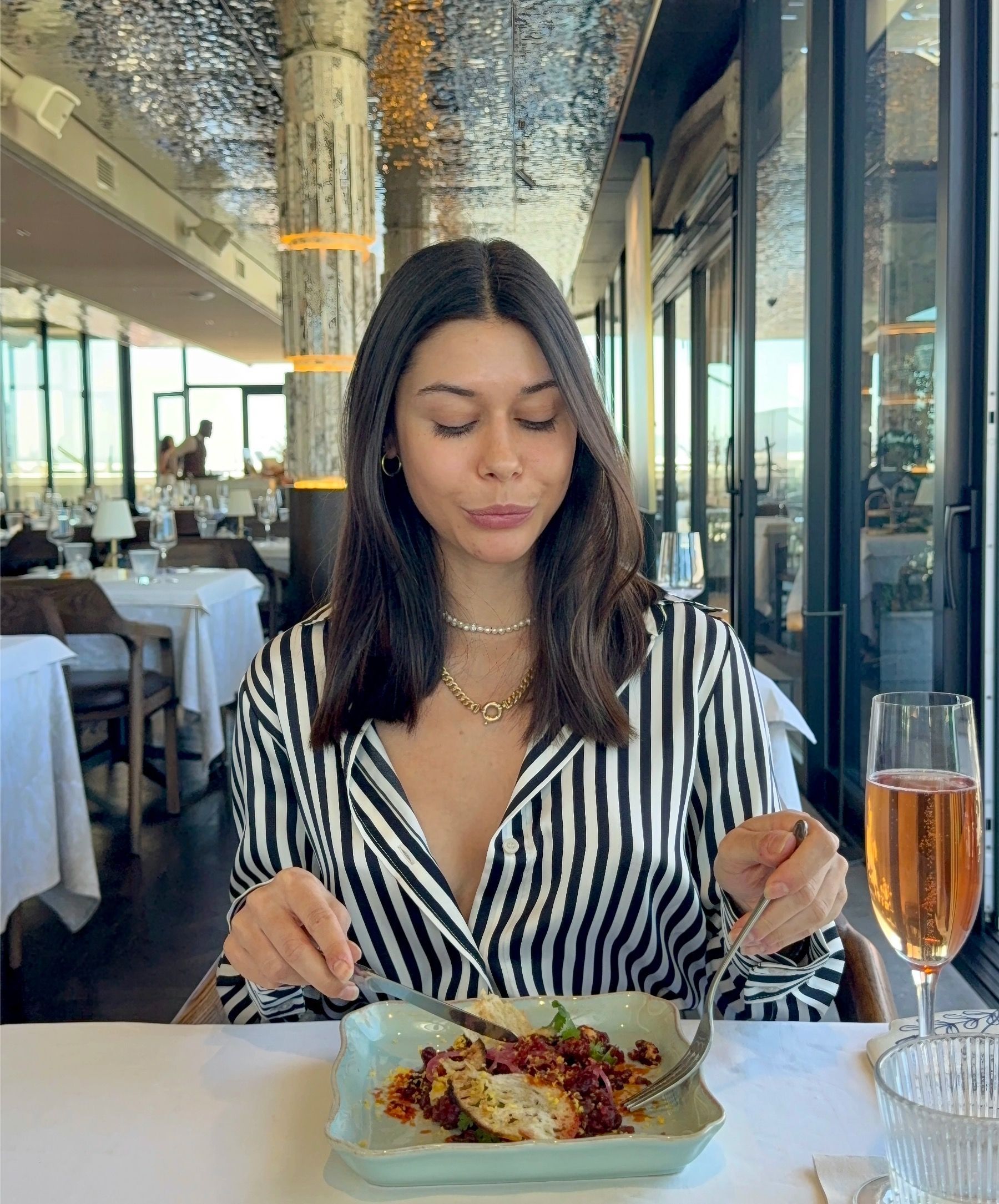 Paige tasting game tartare with chilli oil and cured yolk at Marble Cape Town.
