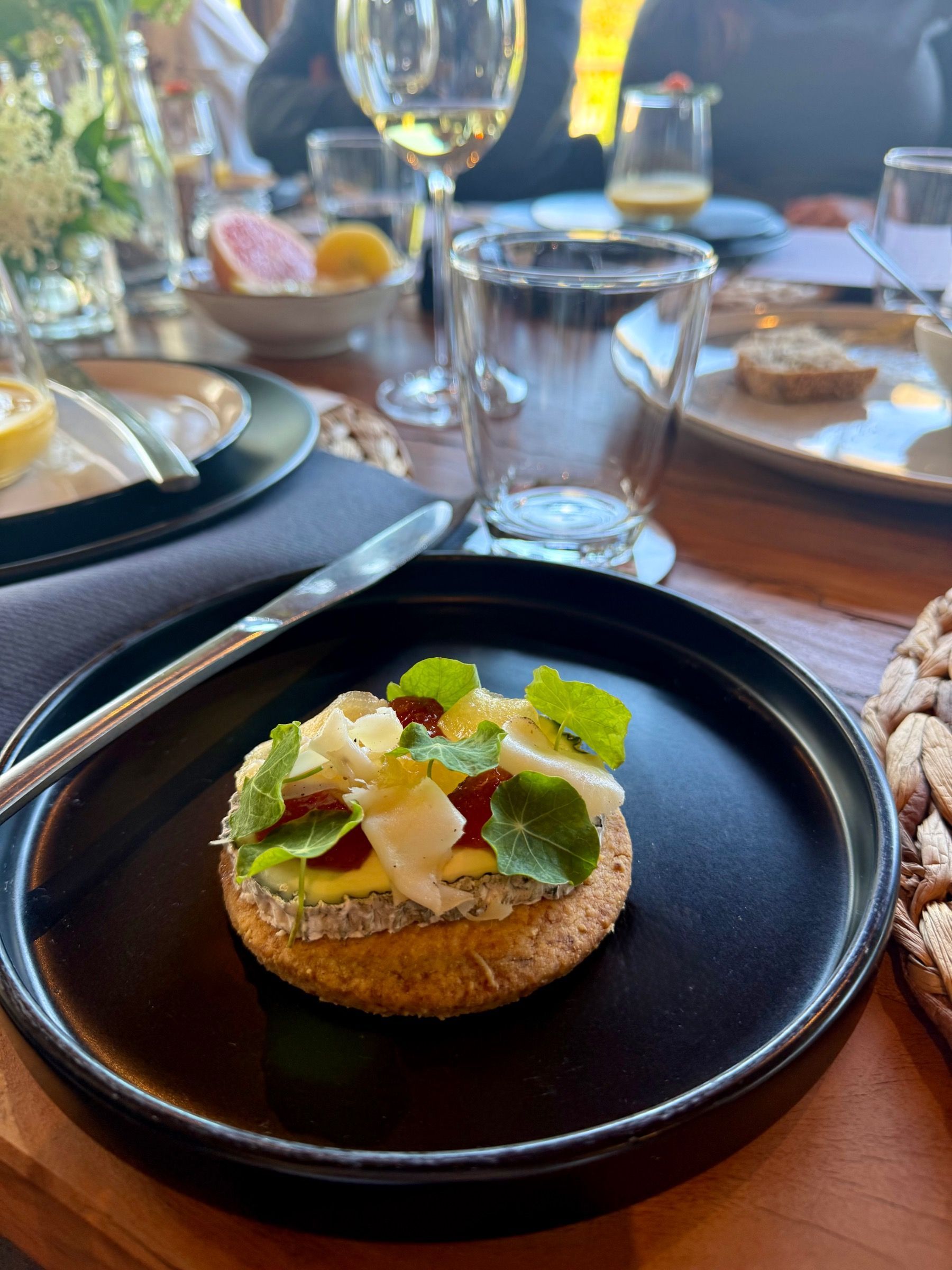 Golden goat’s cheese tart with floral jelly and microgreens served at Meuse Farm x Painted Wolf Wines pairing dinner
