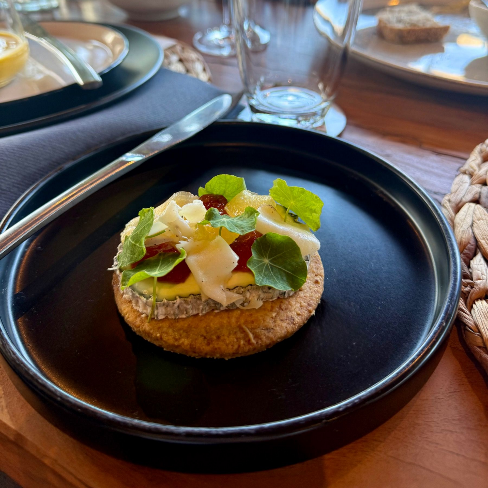 Golden goat’s cheese tart with floral jelly and microgreens served at Meuse Farm x Painted Wolf Wines pairing dinner