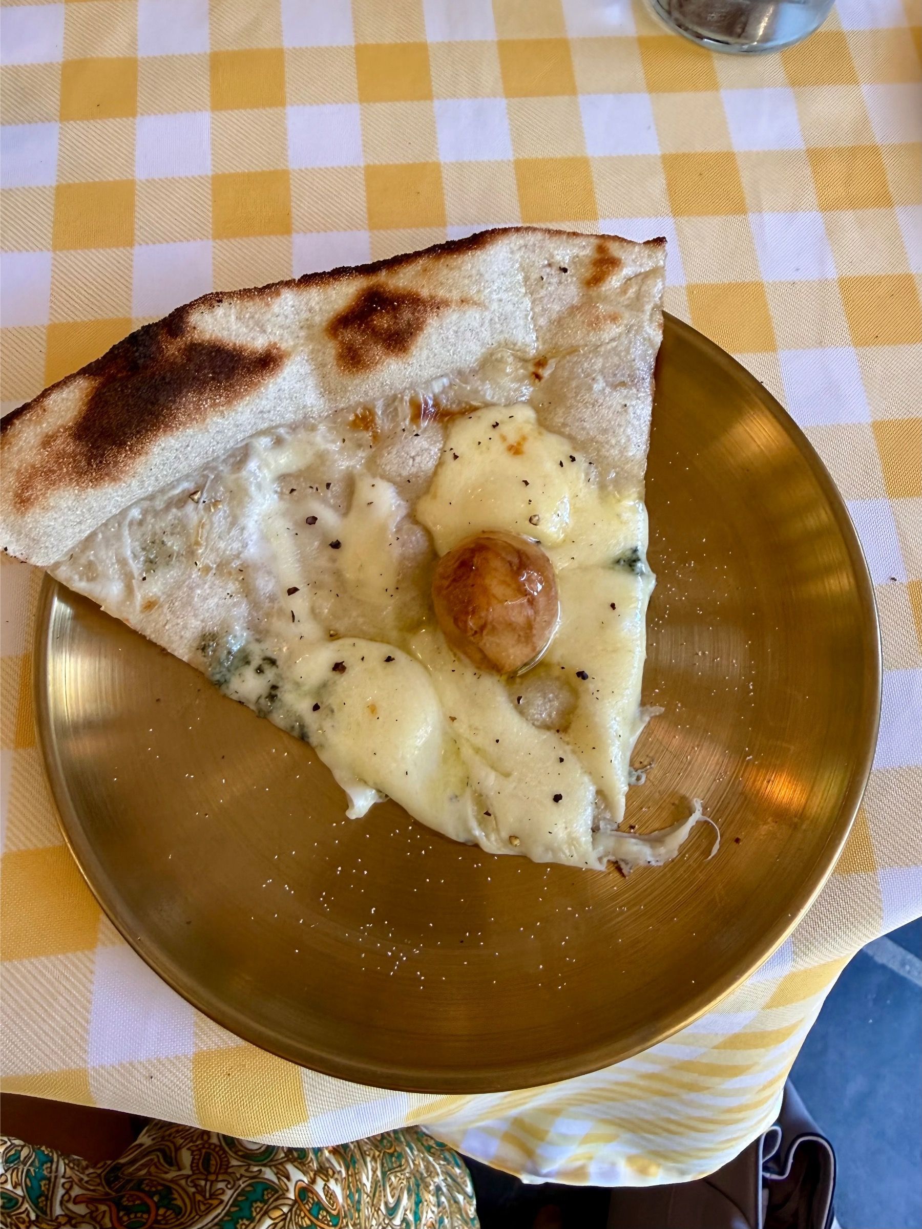 Quattro Formaggi pizza slice at Motherdough Jonkershoek. Gorgonzola, smoked mozzarella and Italian cheeses sourdough 