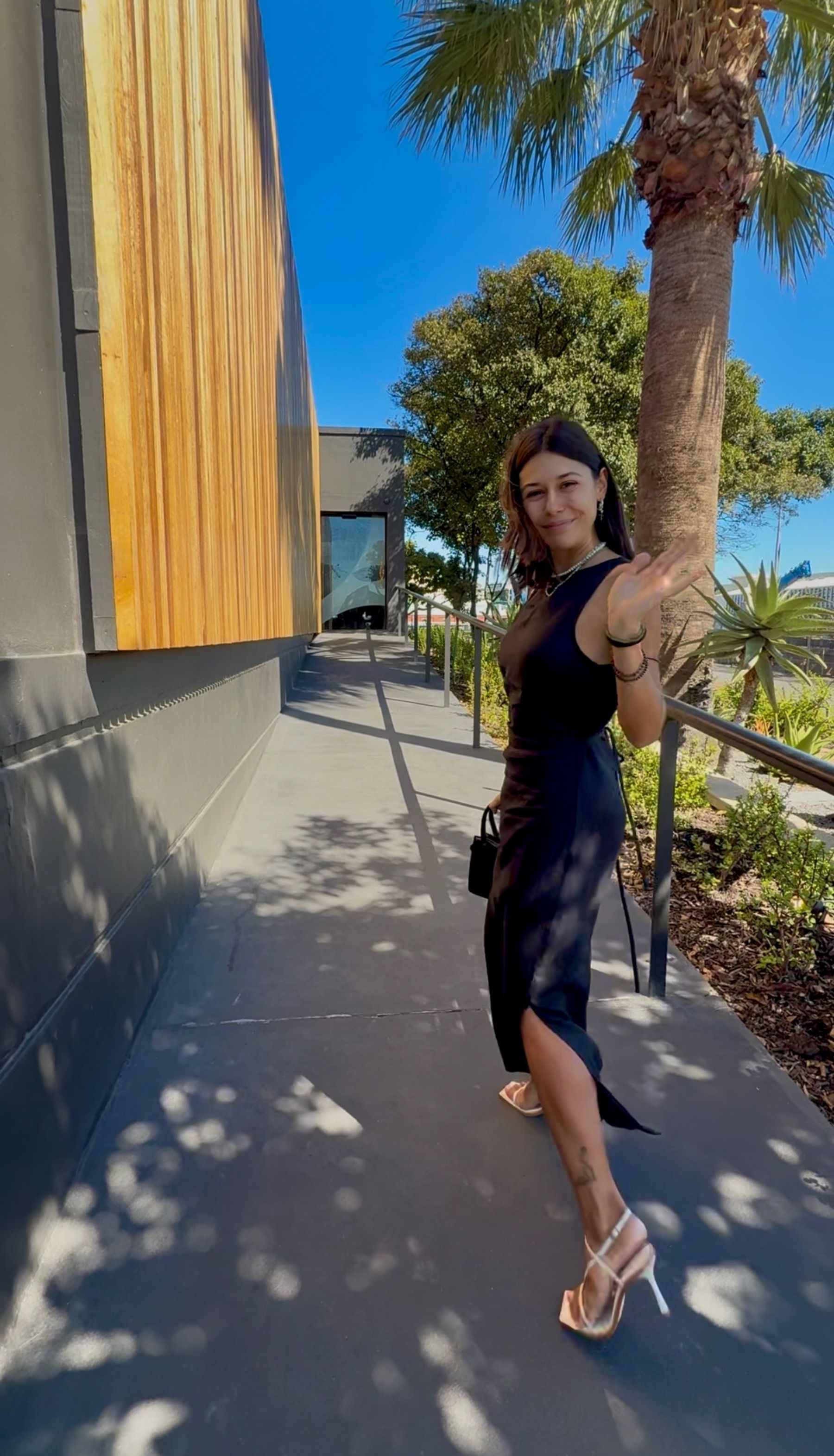 Paige waving at the entrance of Coy Restaurant, The Waterfront, Cape Town