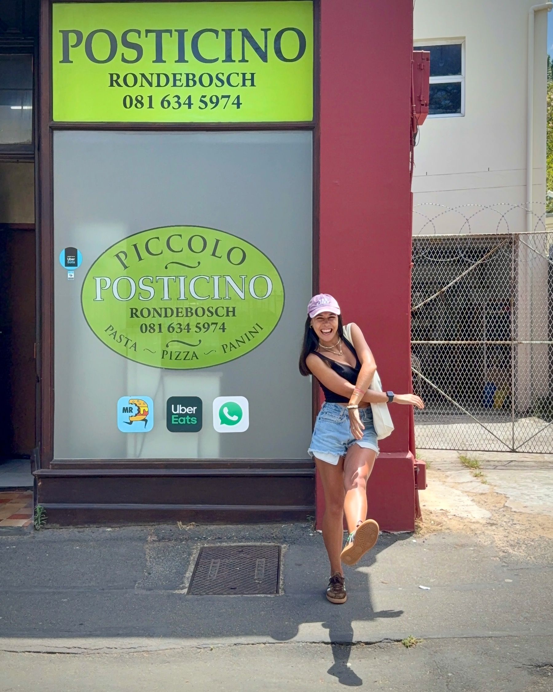 Paige outside Piccolo Posticino Rondebosch smiling and excited for pizza 