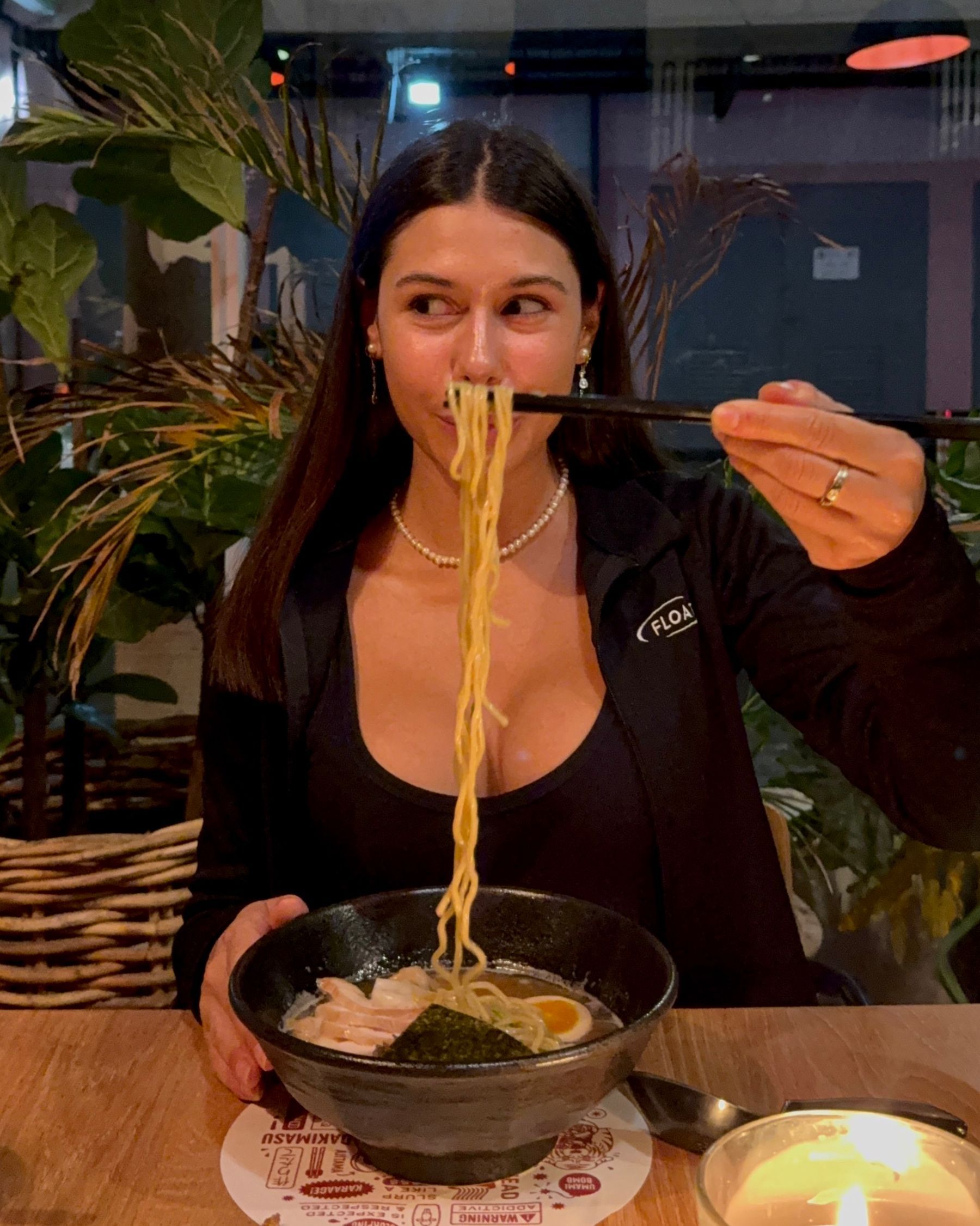 Paige is eating ramen noodles at Ramenhead Cape Town