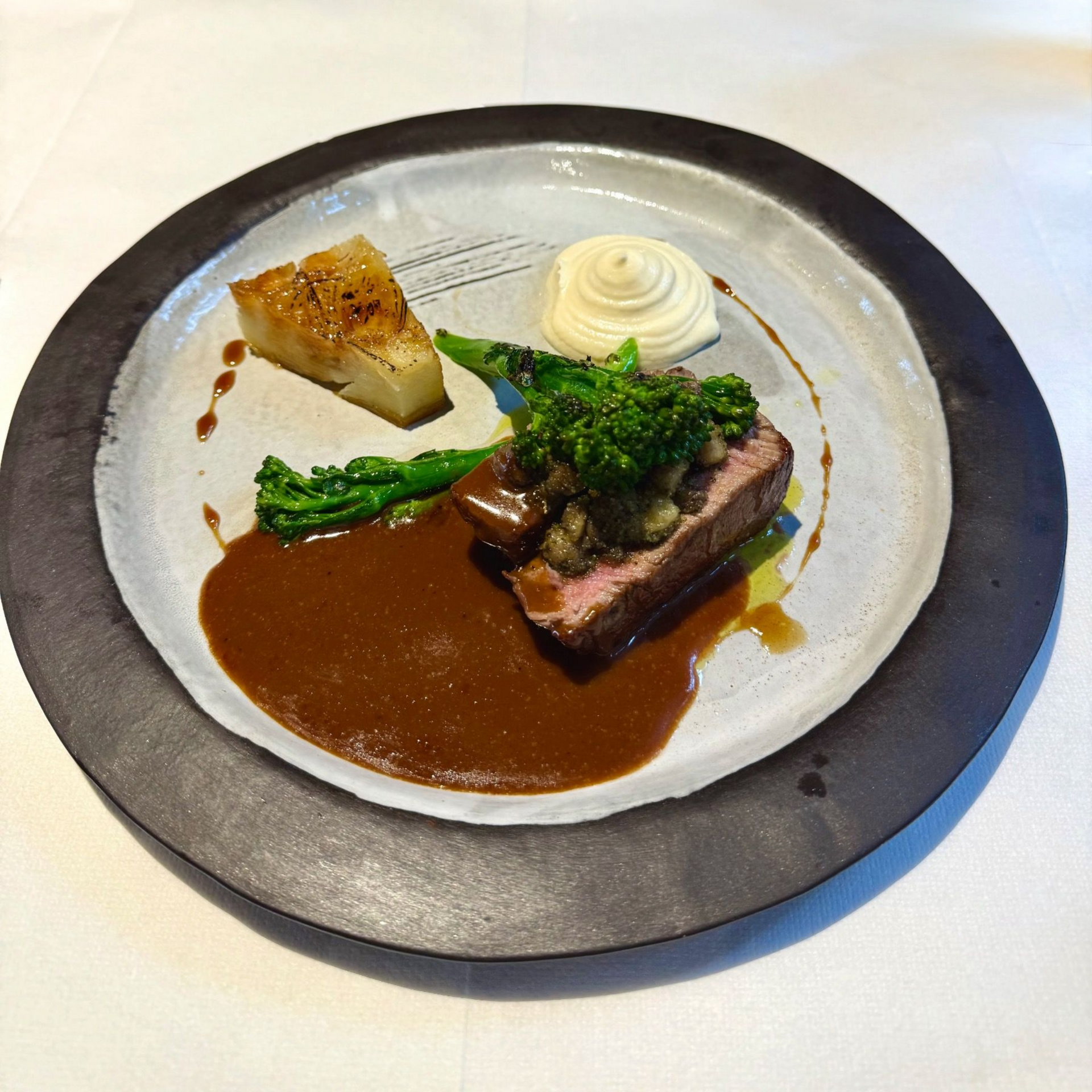 Beef fillet with signature sauce and seasonal garnish at The Test Kitchen